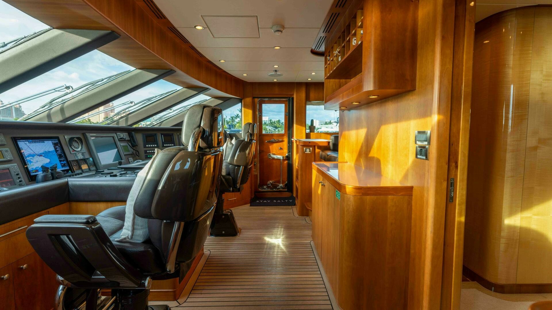 a room with a wood cabinet and chairs and a wood cabinet aboard STAY SALTY Yacht for Sale