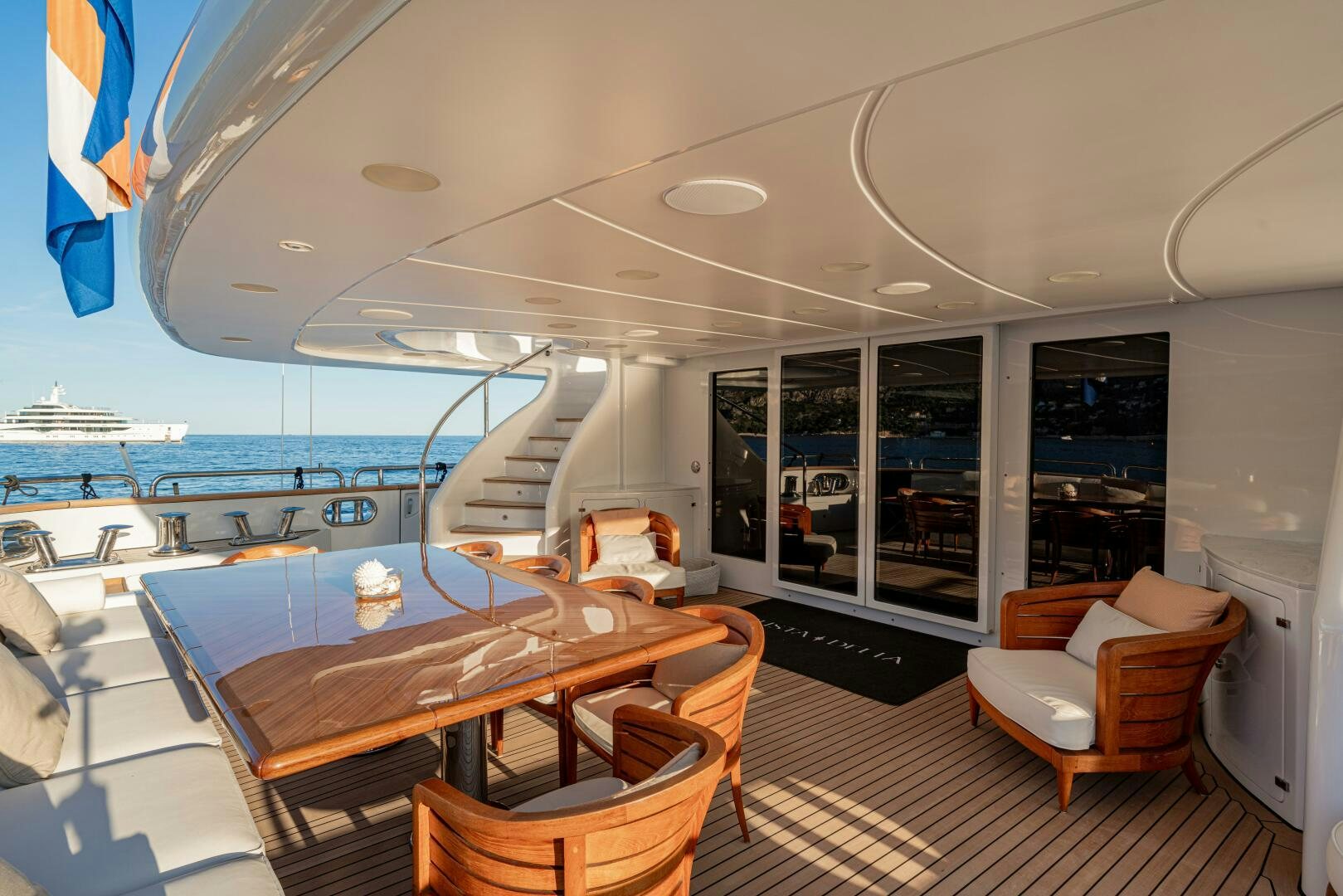 a room with a table chairs and a view of the water aboard JUSTA DELIA Yacht for Sale