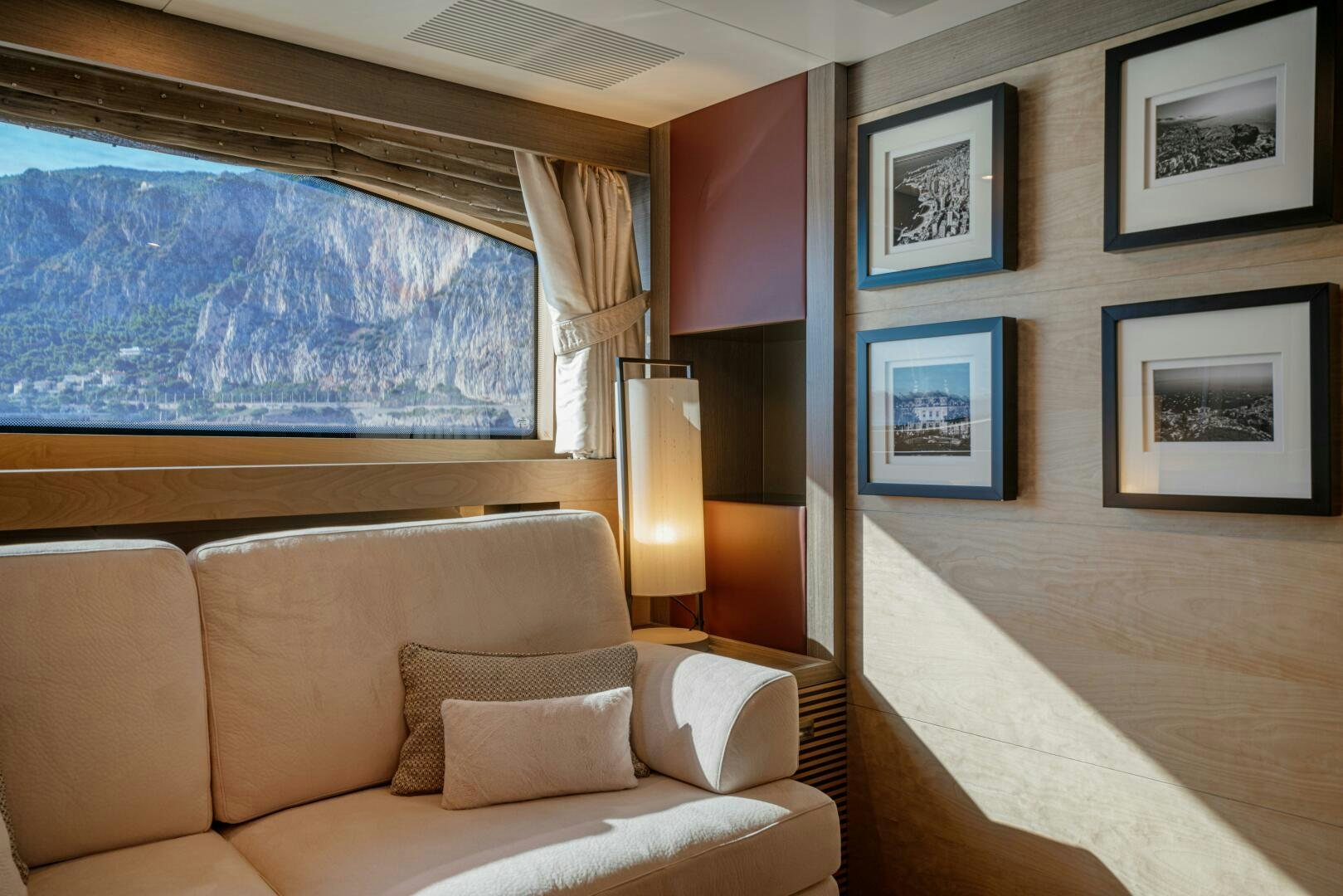 a room with a couch and a window aboard JUSTA DELIA Yacht for Sale