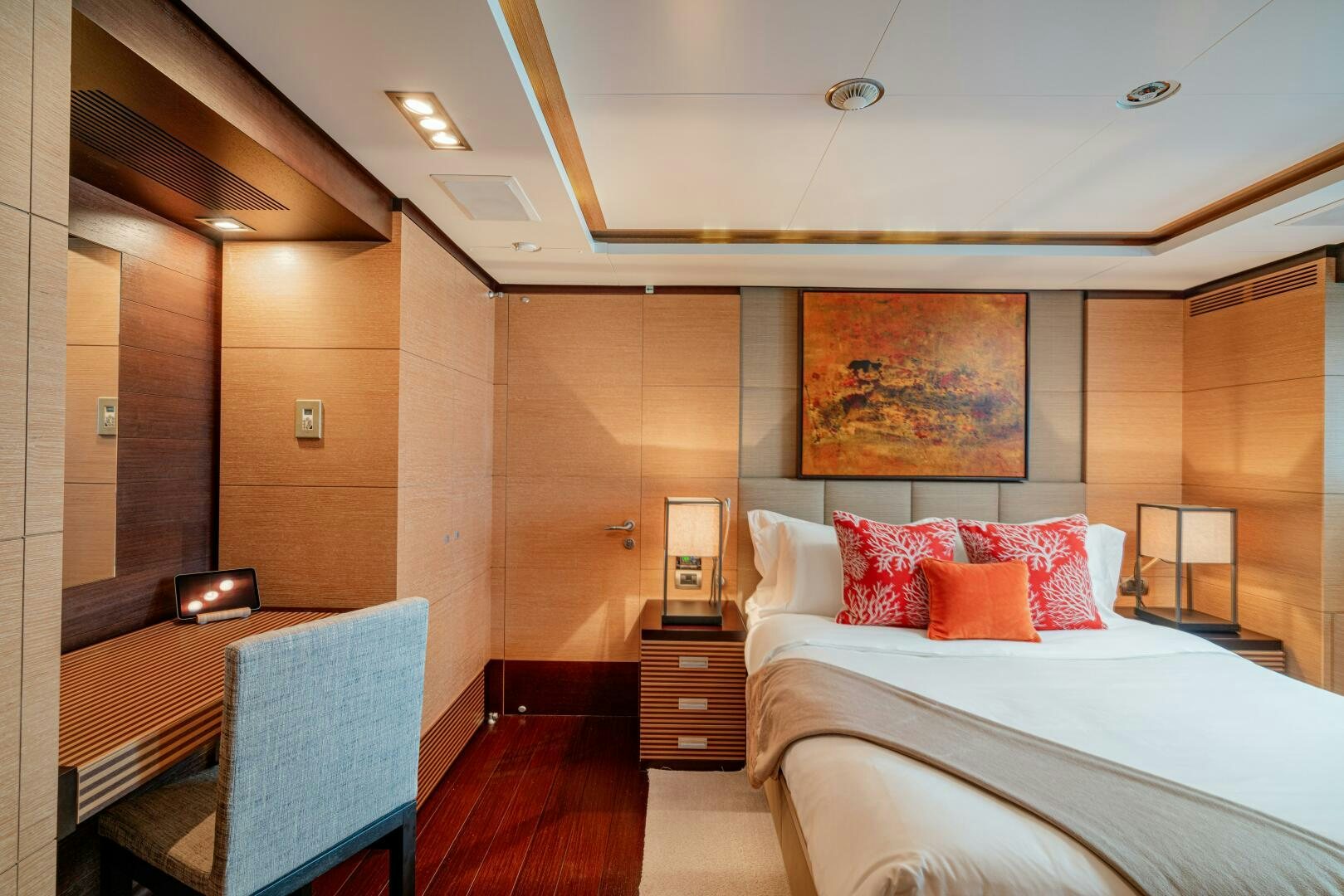 a room with a bed and a chair aboard JUSTA DELIA Yacht for Sale