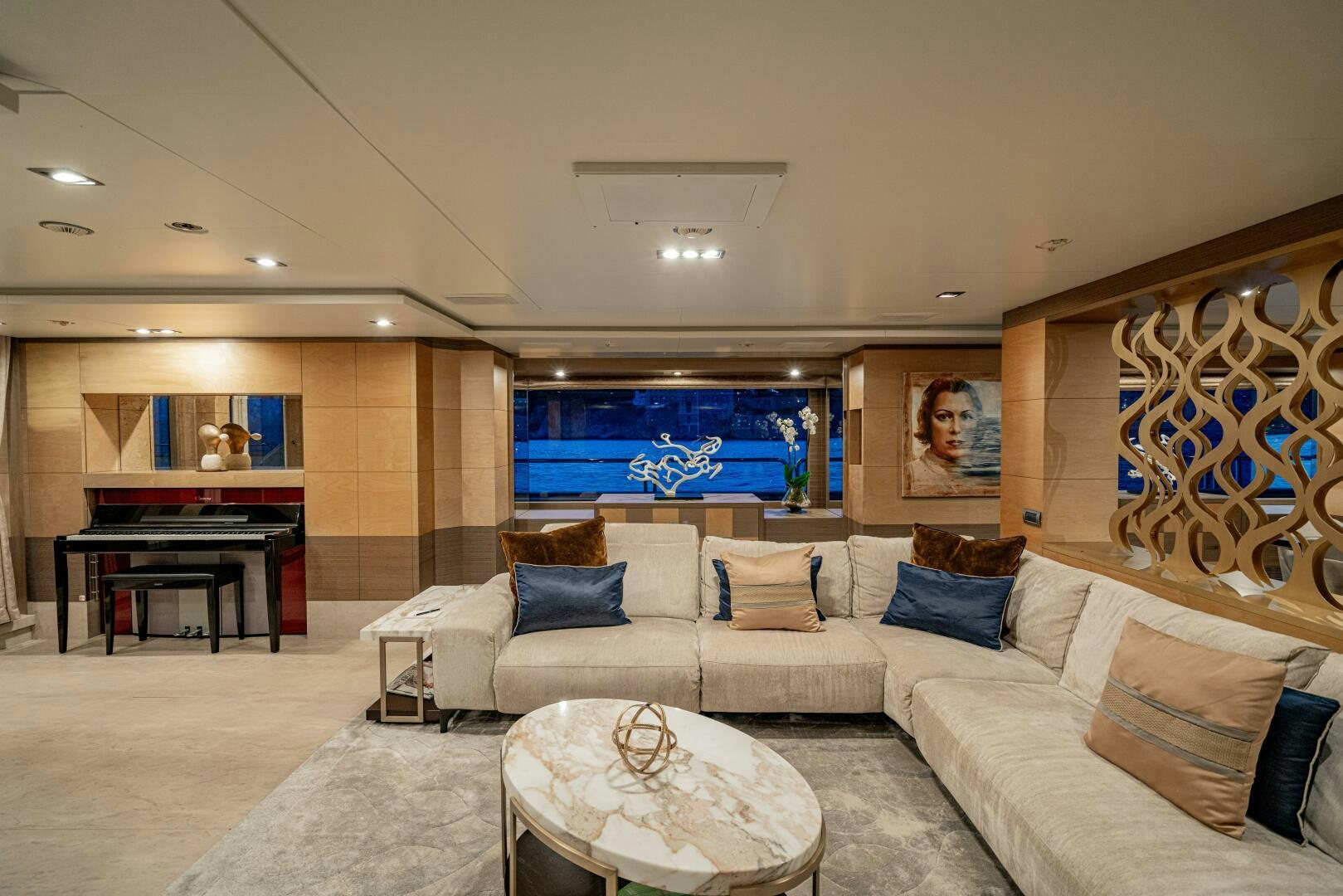 a living room with a large white couch and a fireplace aboard JUSTA DELIA Yacht for Sale