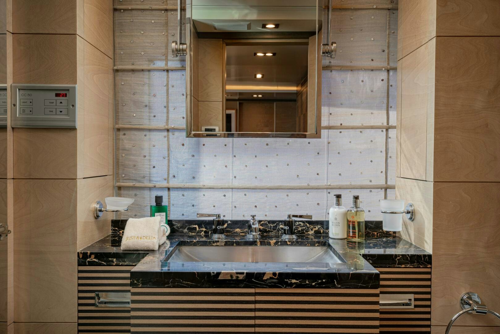 a bathroom with a sink and a mirror aboard JUSTA DELIA Yacht for Sale