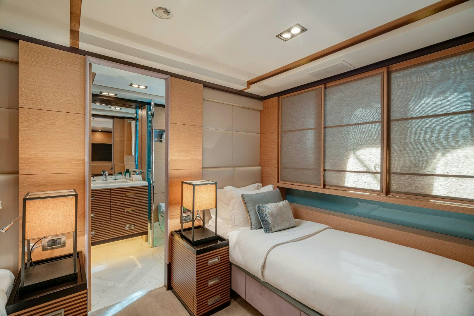 a bedroom with a bed and a mirror aboard JUSTA DELIA Yacht for Sale