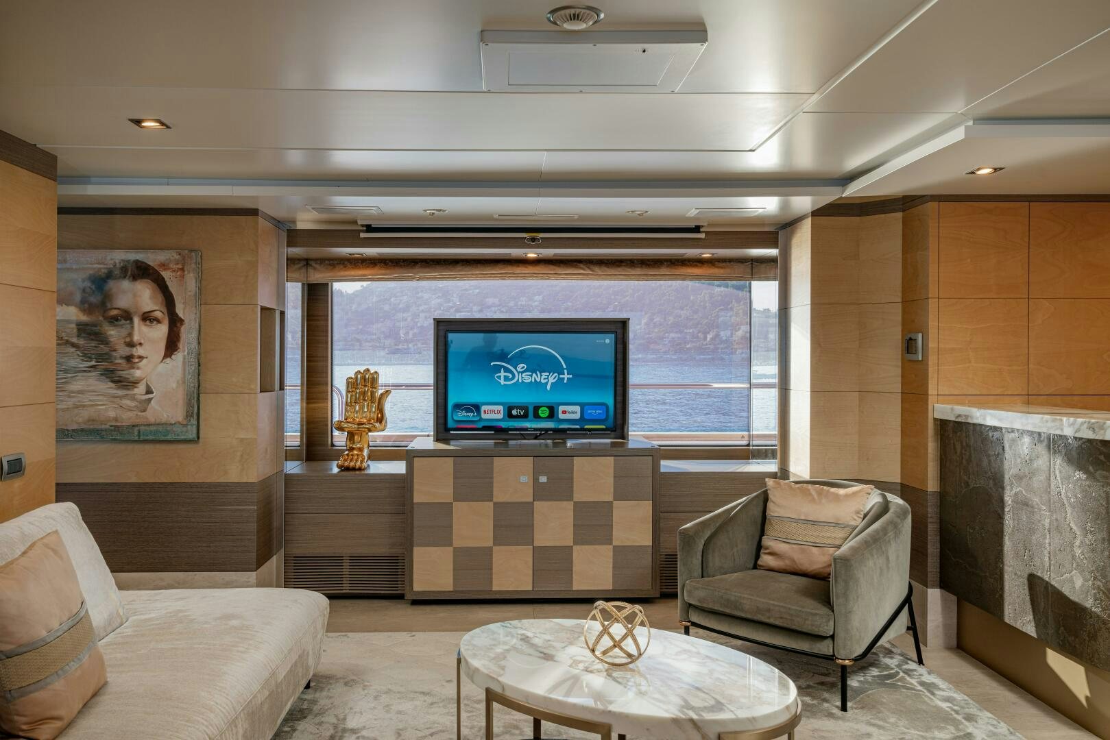 a room with a tv and couches aboard JUSTA DELIA Yacht for Sale