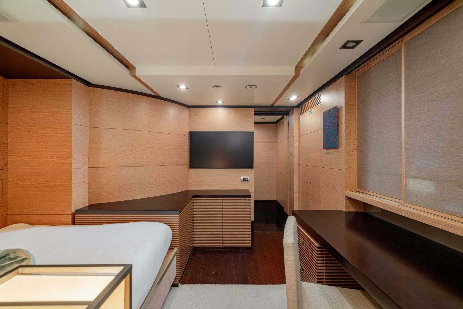 a room with a bed and a desk aboard JUSTA DELIA Yacht for Sale