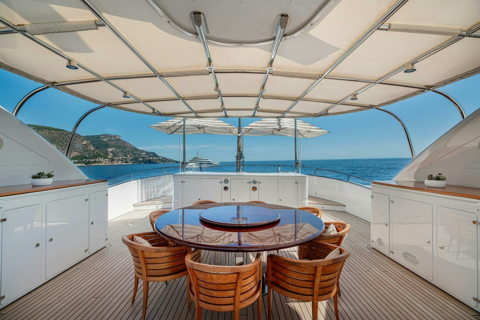 a table and chairs on a deck aboard JUSTA DELIA Yacht for Sale