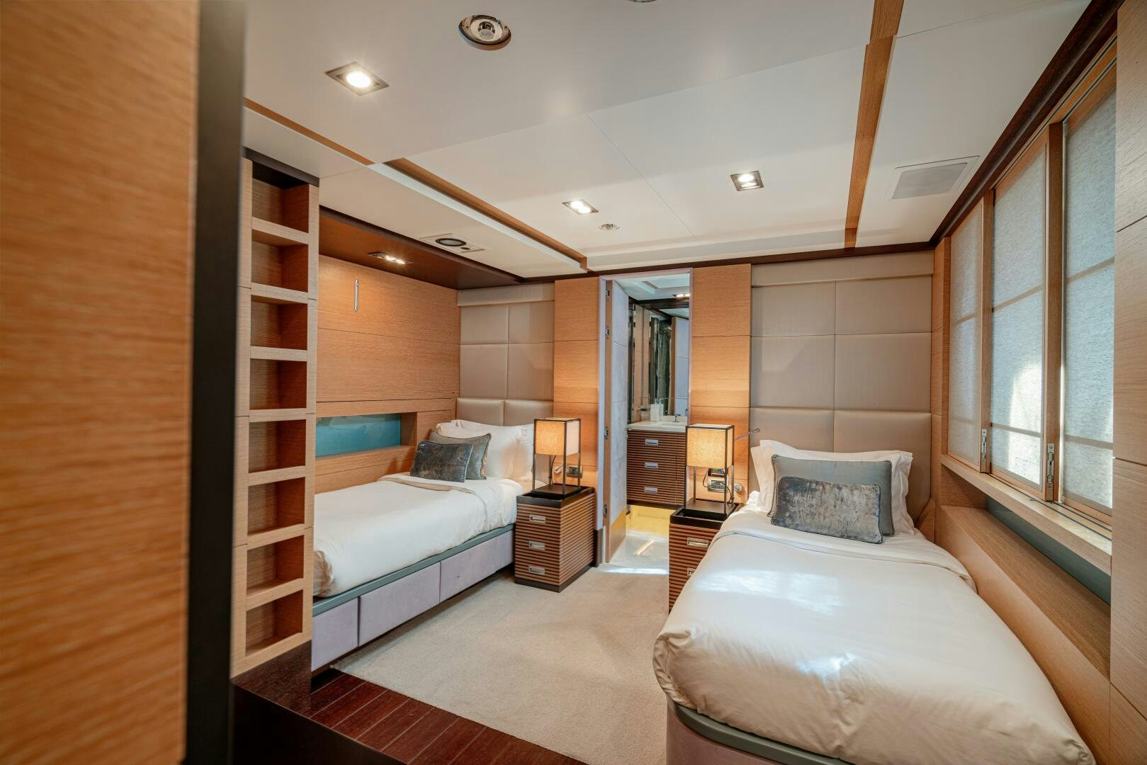 a bedroom with a bed and a bookcase aboard JUSTA DELIA Yacht for Sale