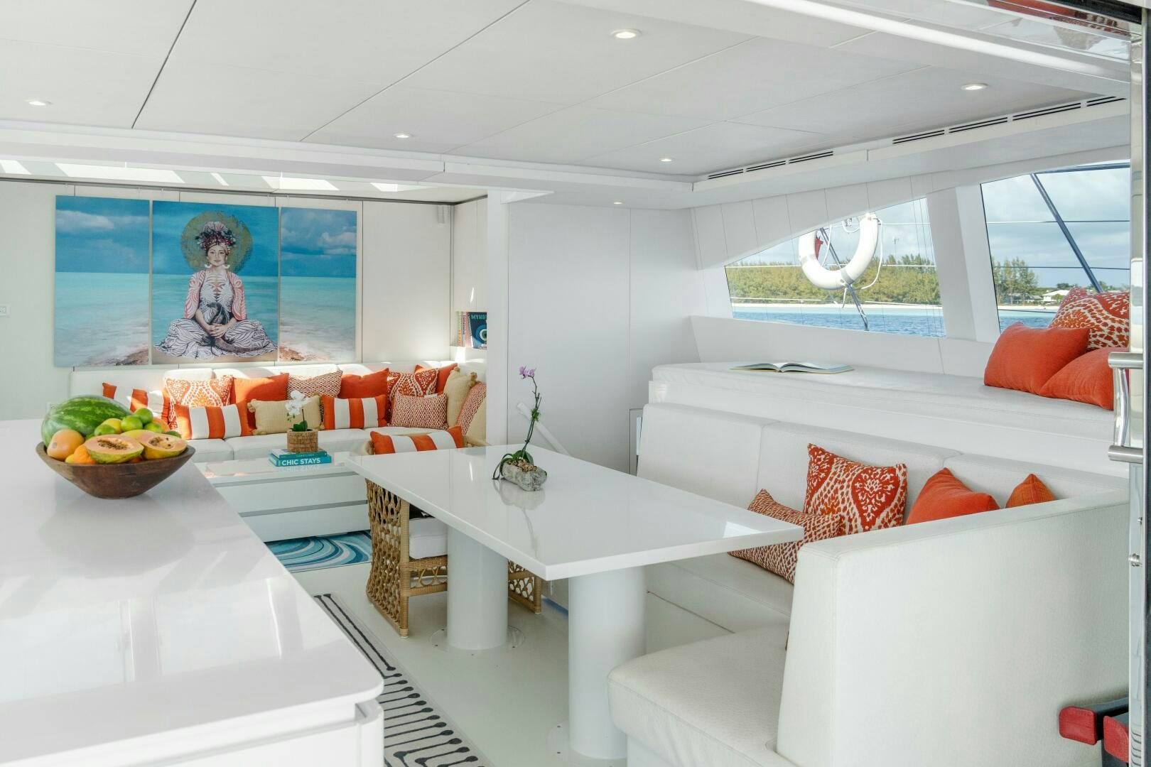 a white living room with a white couch and a white table aboard ROYAL RITA Yacht for Sale