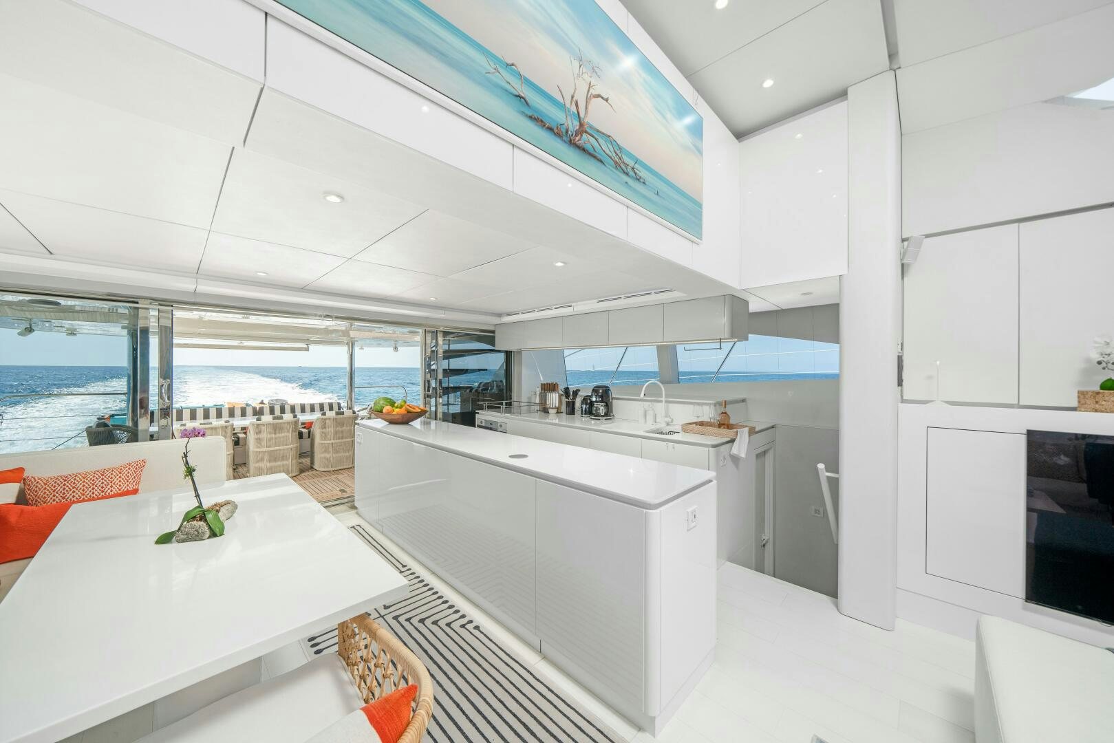 a modern kitchen with white cabinets aboard ROYAL RITA Yacht for Sale