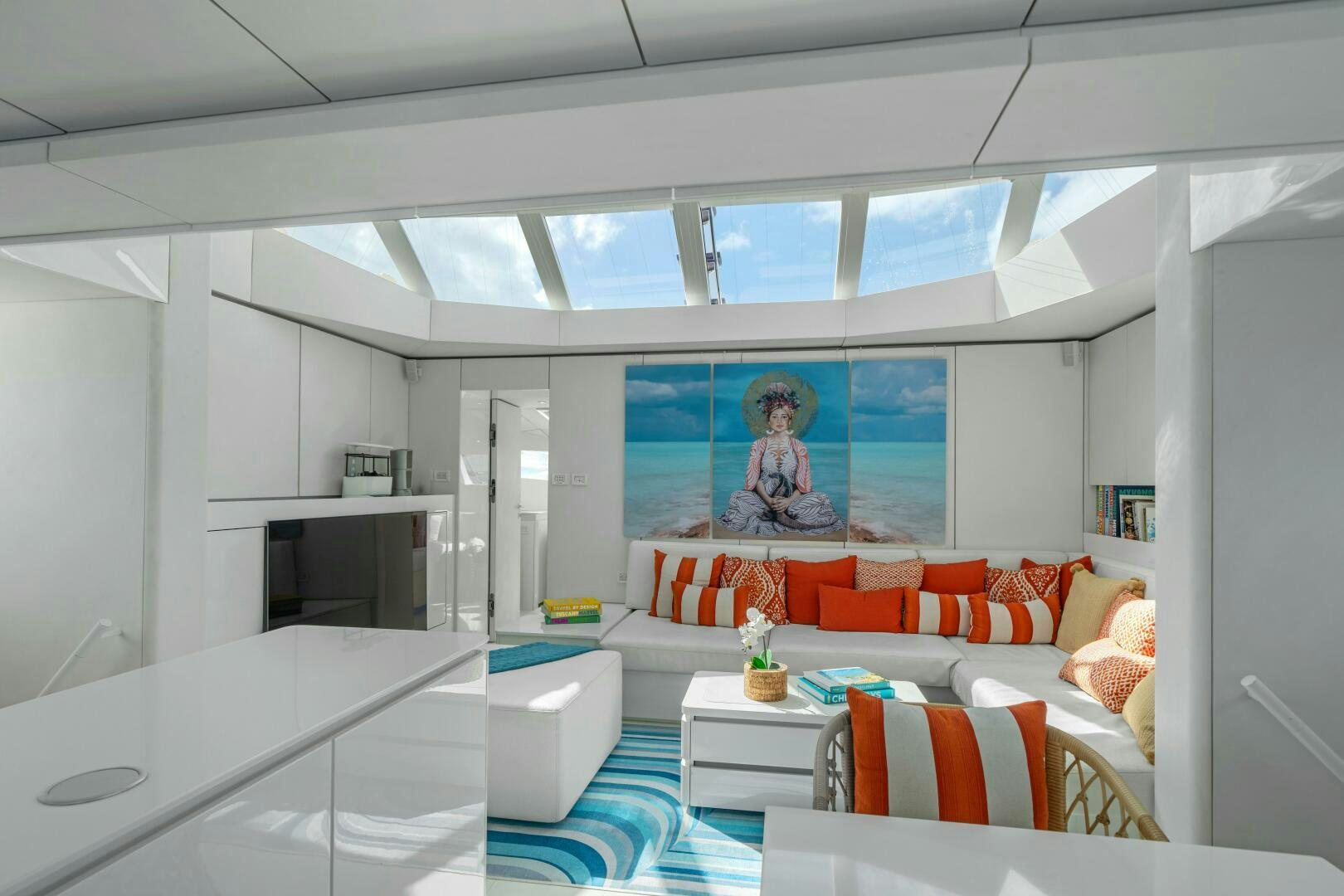 a living room with a white couch and a television aboard ROYAL RITA Yacht for Sale