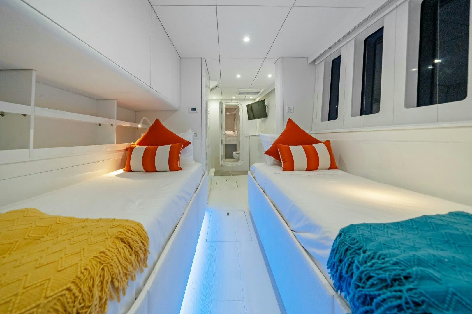 a room with a bed and a couple of beds aboard ROYAL RITA Yacht for Sale