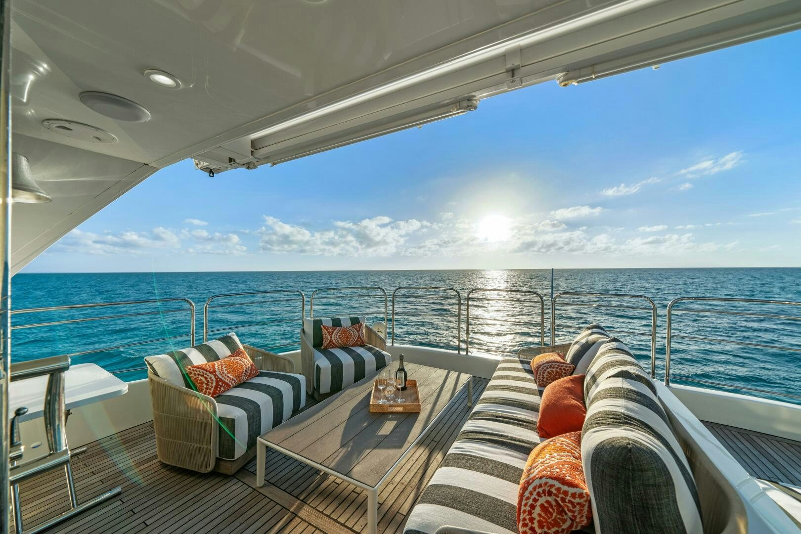 a balcony with a view of the ocean and the sun aboard ROYAL RITA Yacht for Sale