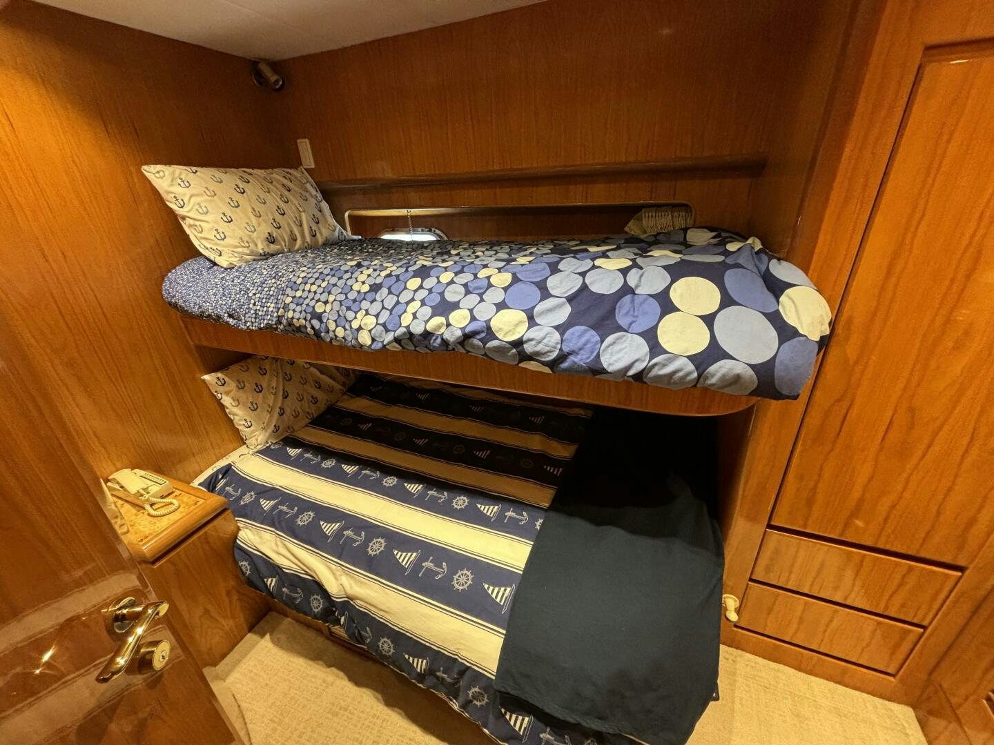 a bed with a blue blanket aboard ROYAL VIKING Yacht for Sale