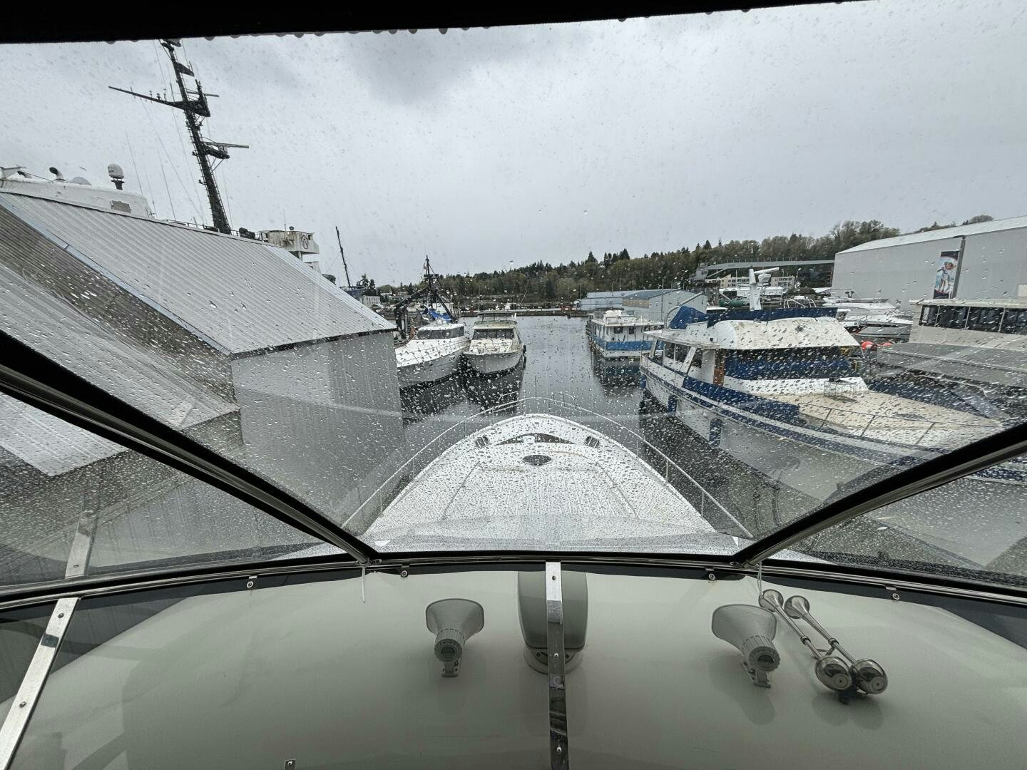 a view of a boat yard with a large building and boats in the water aboard ROYAL VIKING Yacht for Sale