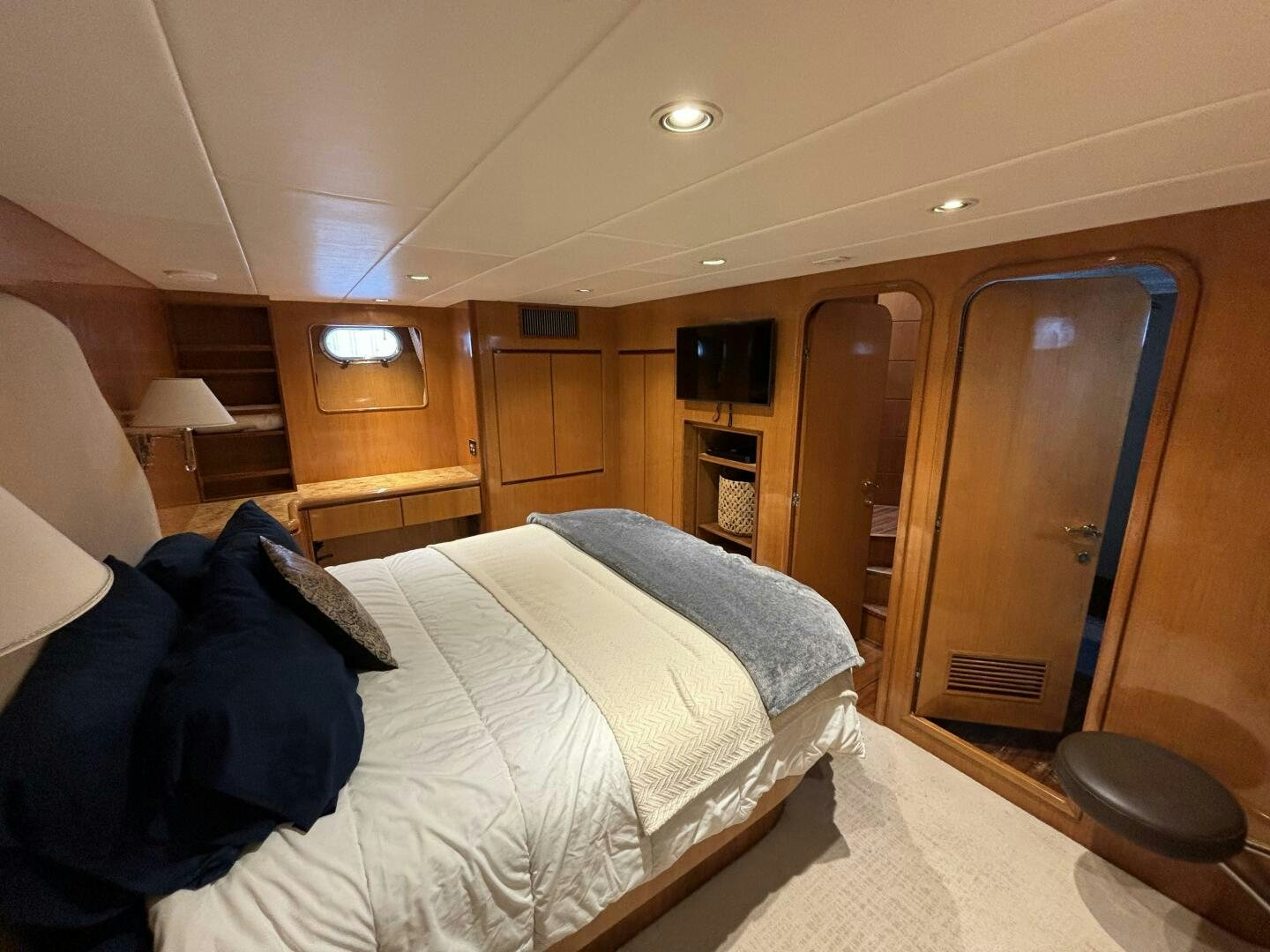 a bedroom with a bed and a closet aboard ROYAL VIKING Yacht for Sale