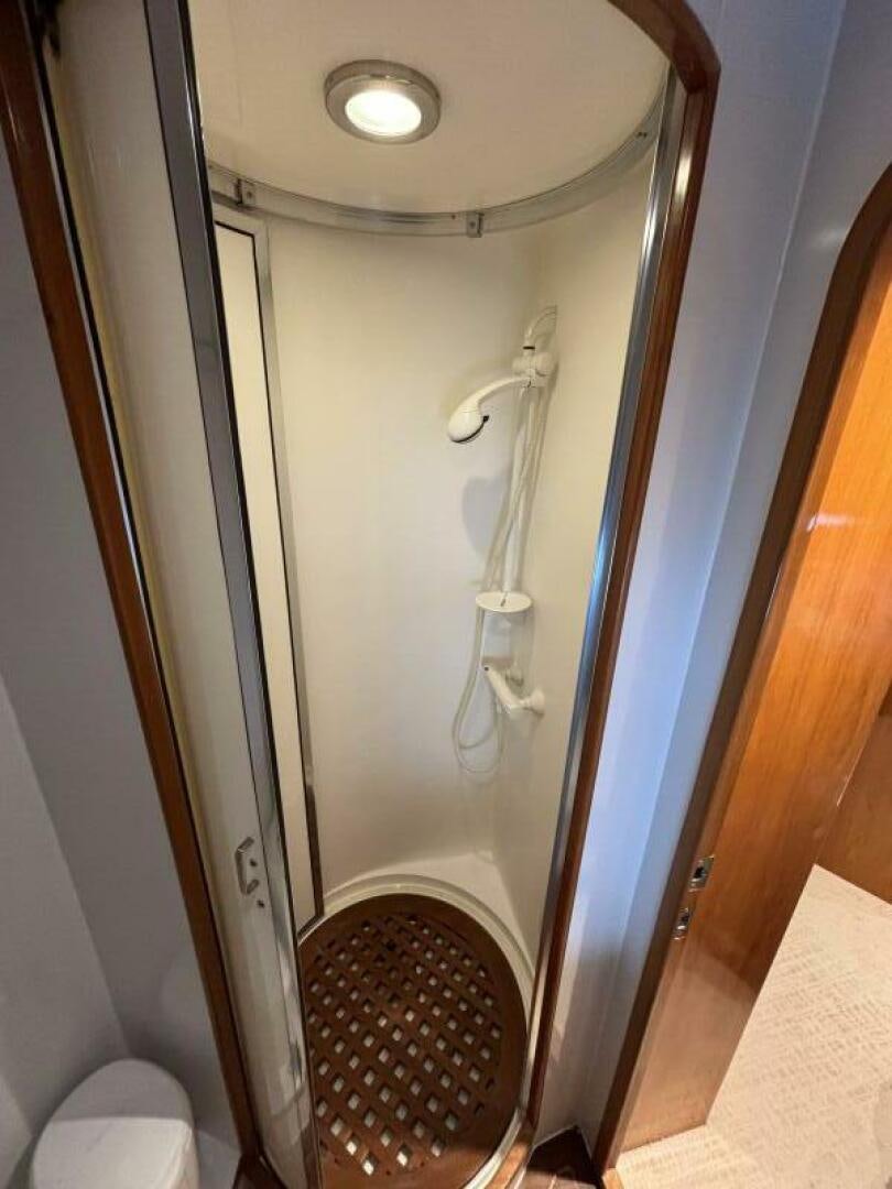 a bathroom with a shower and a toilet aboard ROYAL VIKING Yacht for Sale