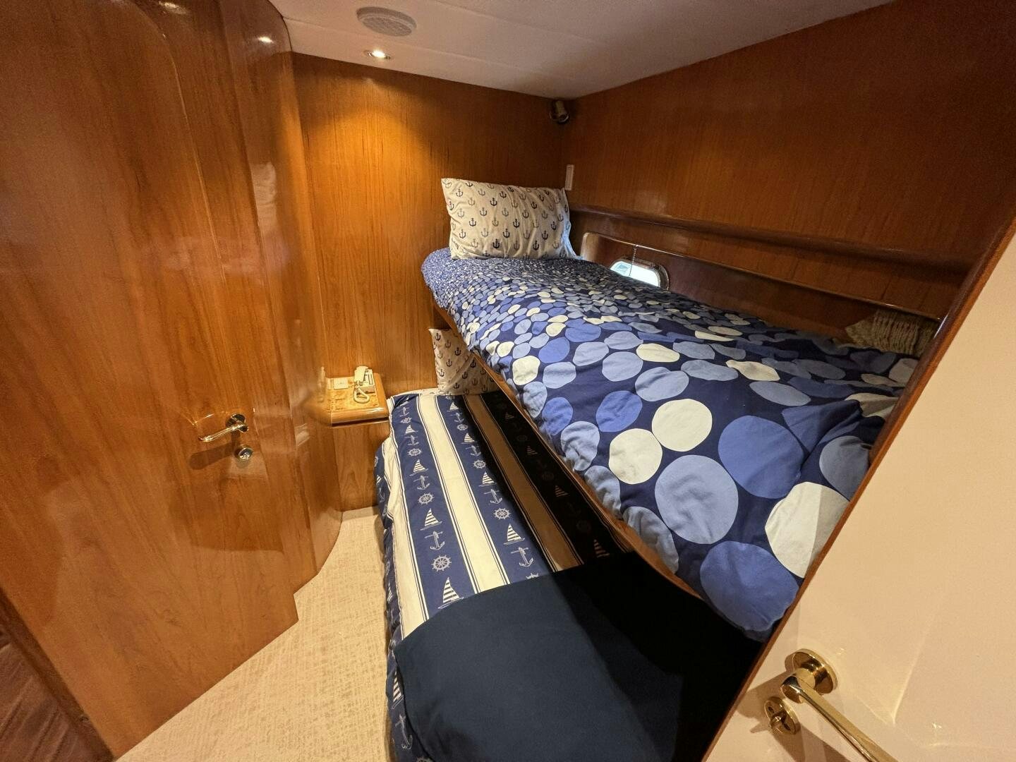 a bed with a blue cover aboard ROYAL VIKING Yacht for Sale