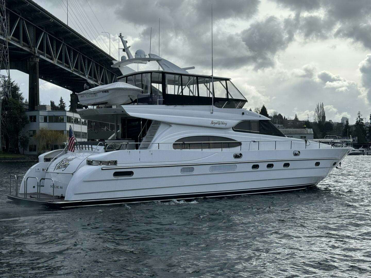 a white yacht in a harbor aboard ROYAL VIKING Yacht for Sale