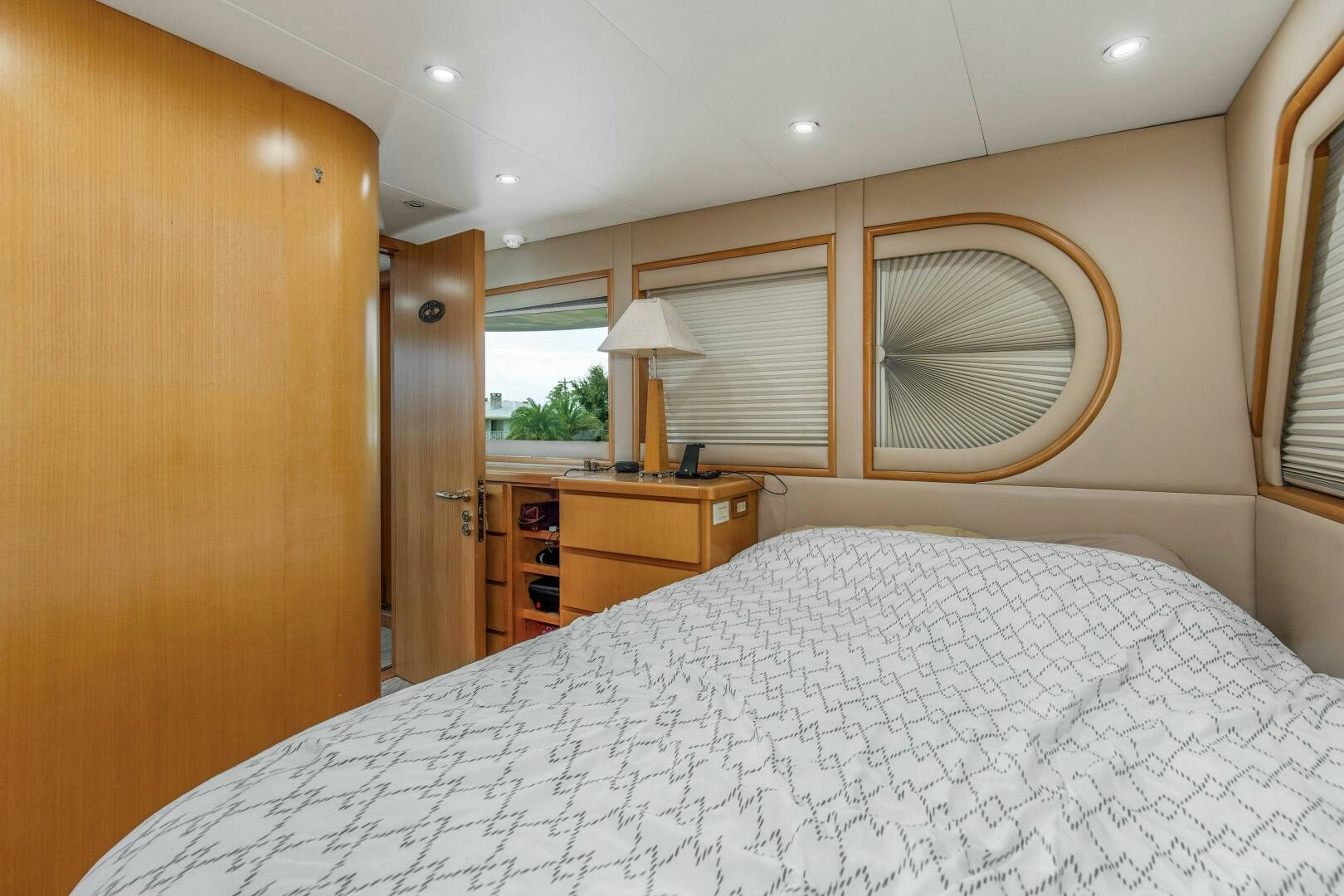 a bedroom with a large mirror aboard BOSS Yacht for Sale