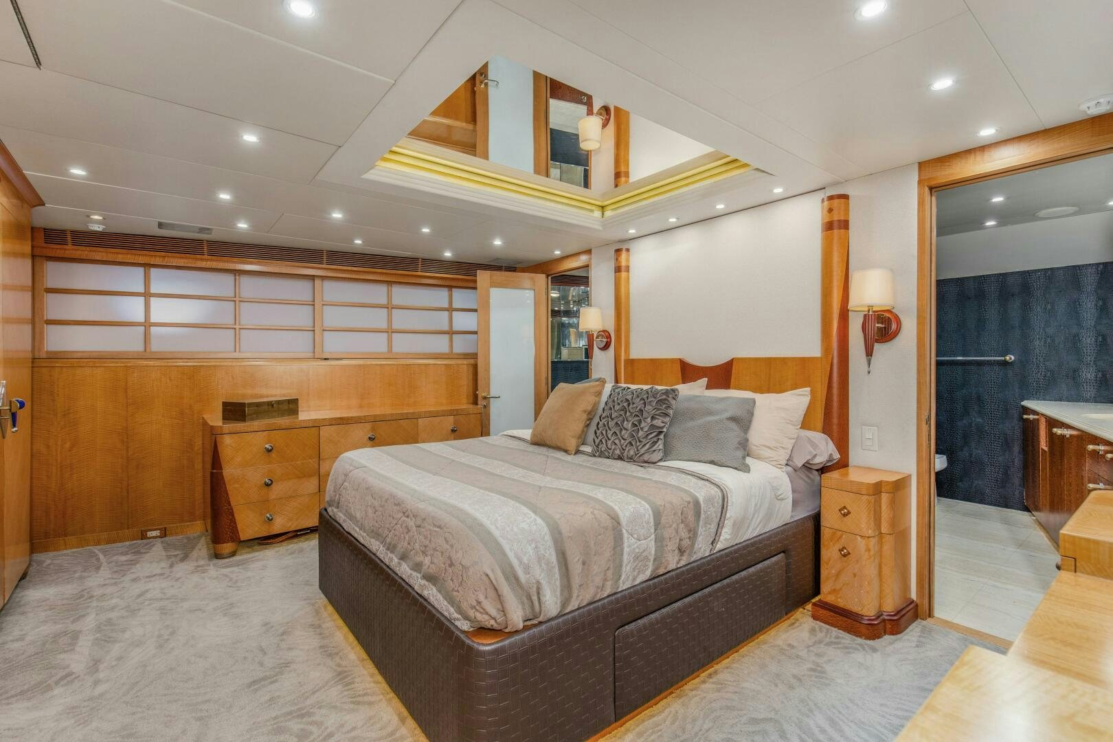 a bedroom with a bed and a desk aboard BOSS Yacht for Sale