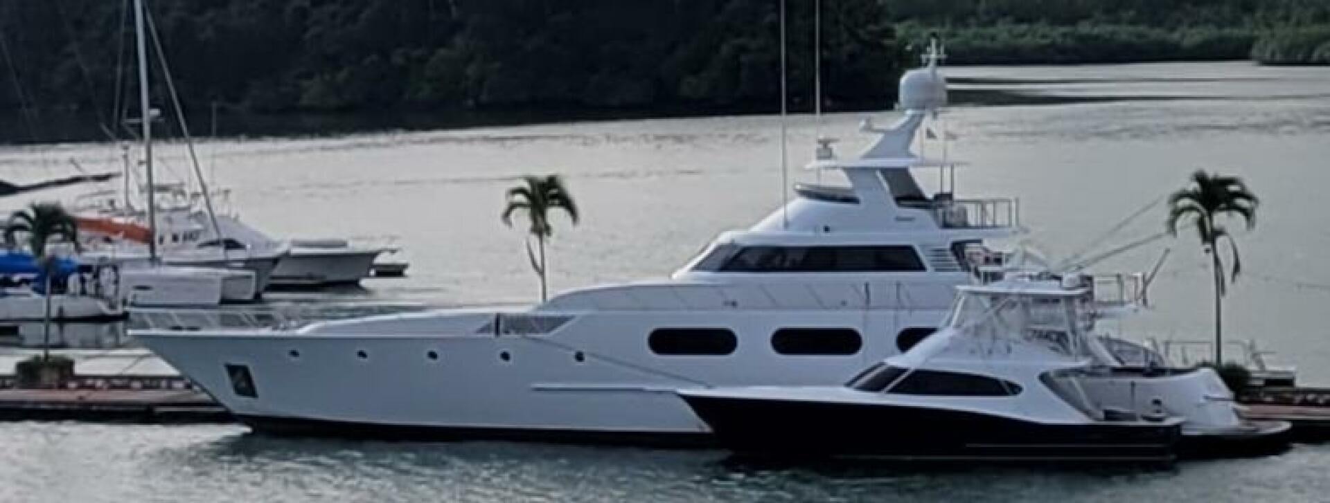 a white yacht on the water aboard BOSS Yacht for Sale