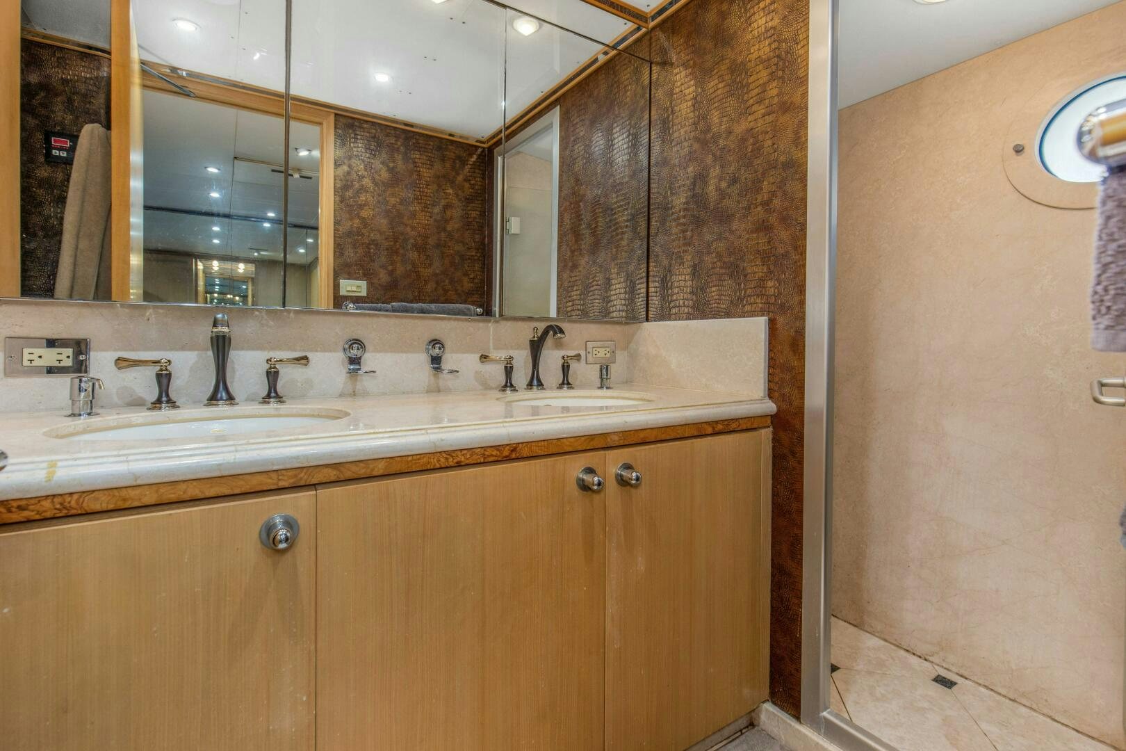 a bathroom with a large mirror aboard BOSS Yacht for Sale