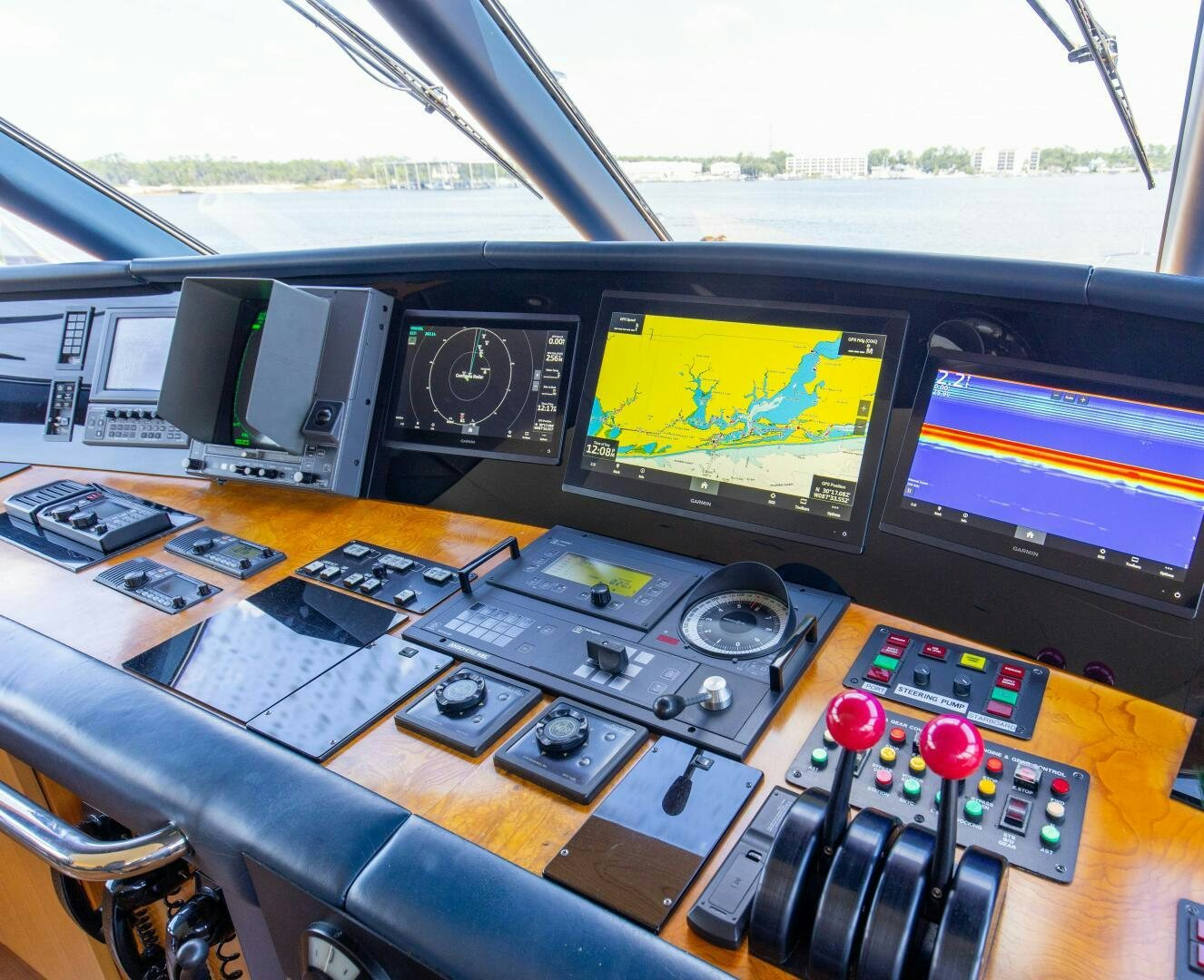 a control panel with multiple monitors aboard BOSS Yacht for Sale