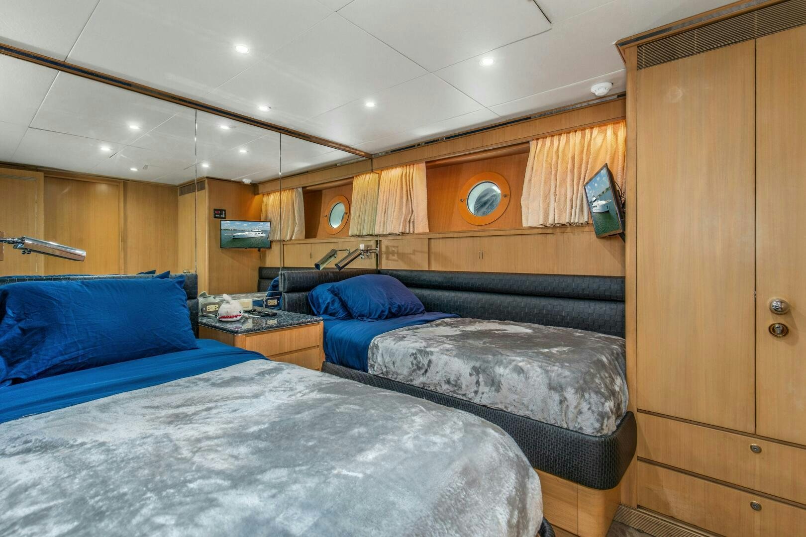 a room with beds and a phone aboard BOSS Yacht for Sale