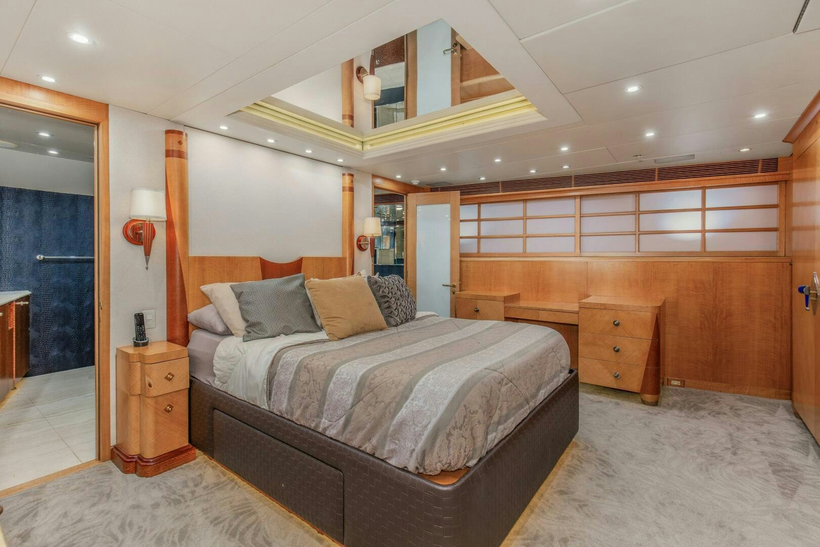 a bedroom with a bed and a wood wall aboard BOSS Yacht for Sale