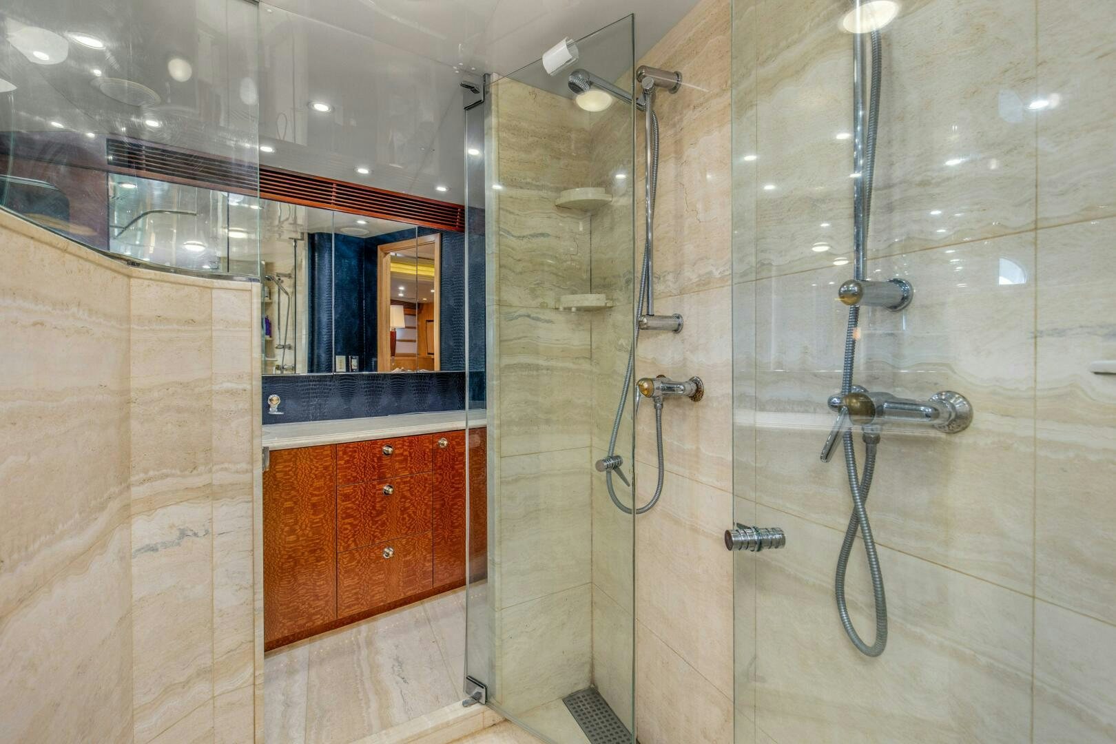 a bathroom with a glass shower aboard BOSS Yacht for Sale