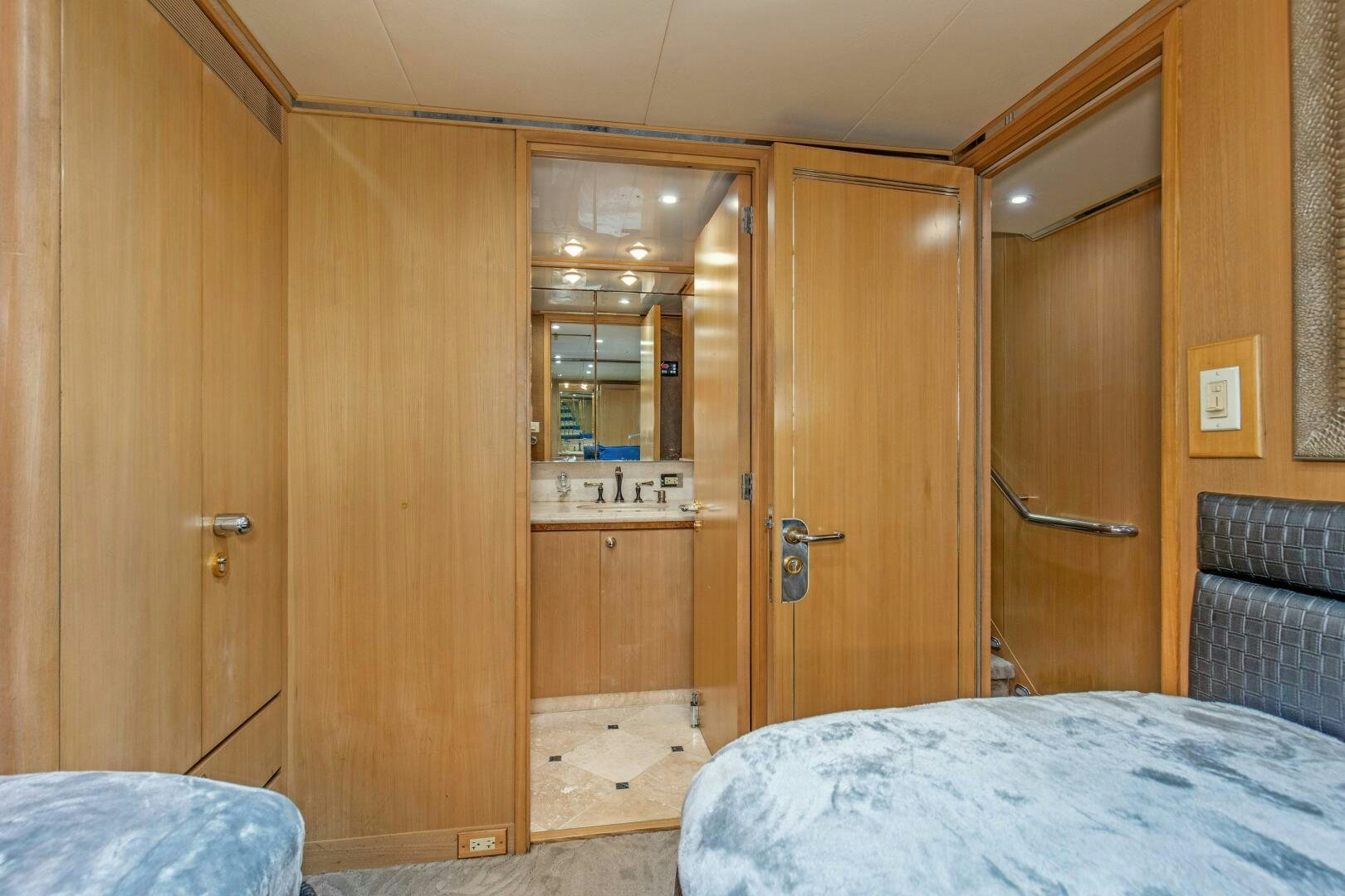 a bedroom with a bed and a closet aboard BOSS Yacht for Sale