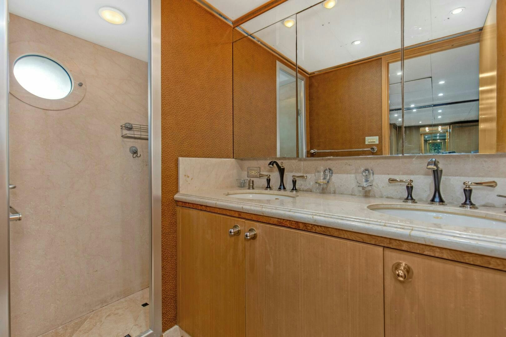 a bathroom with a large mirror aboard BOSS Yacht for Sale