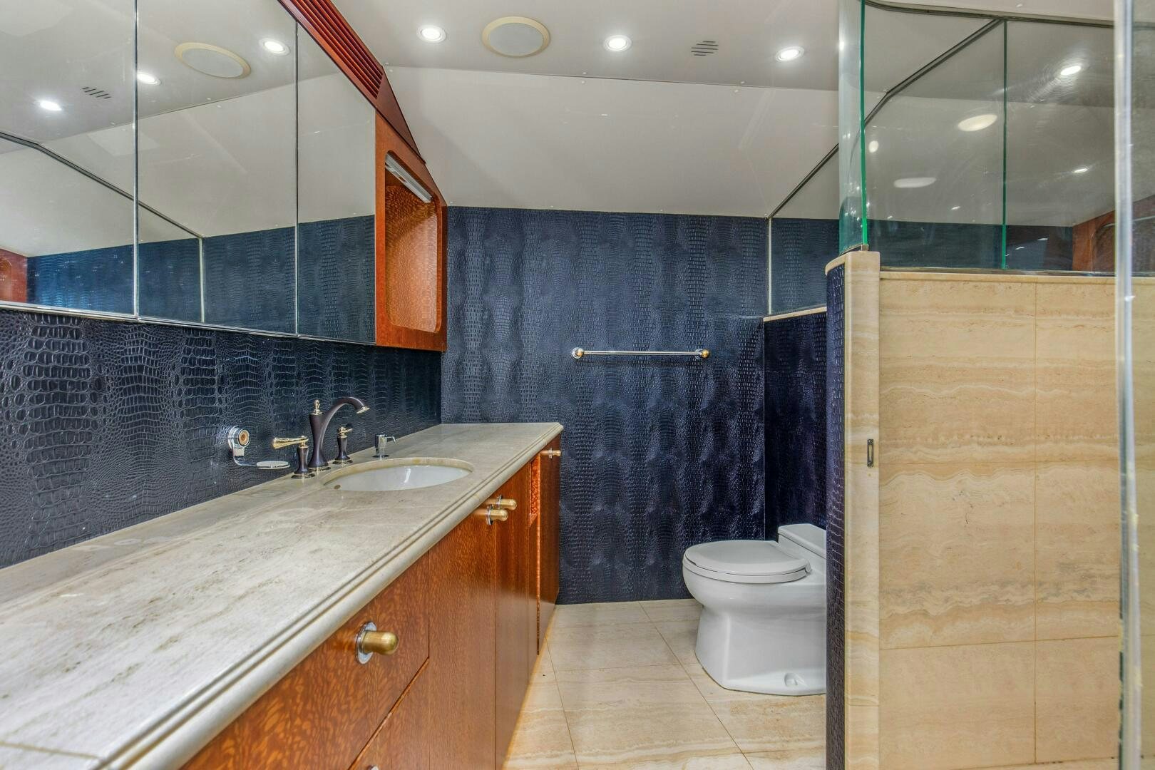 a bathroom with a sink and a toilet aboard BOSS Yacht for Sale
