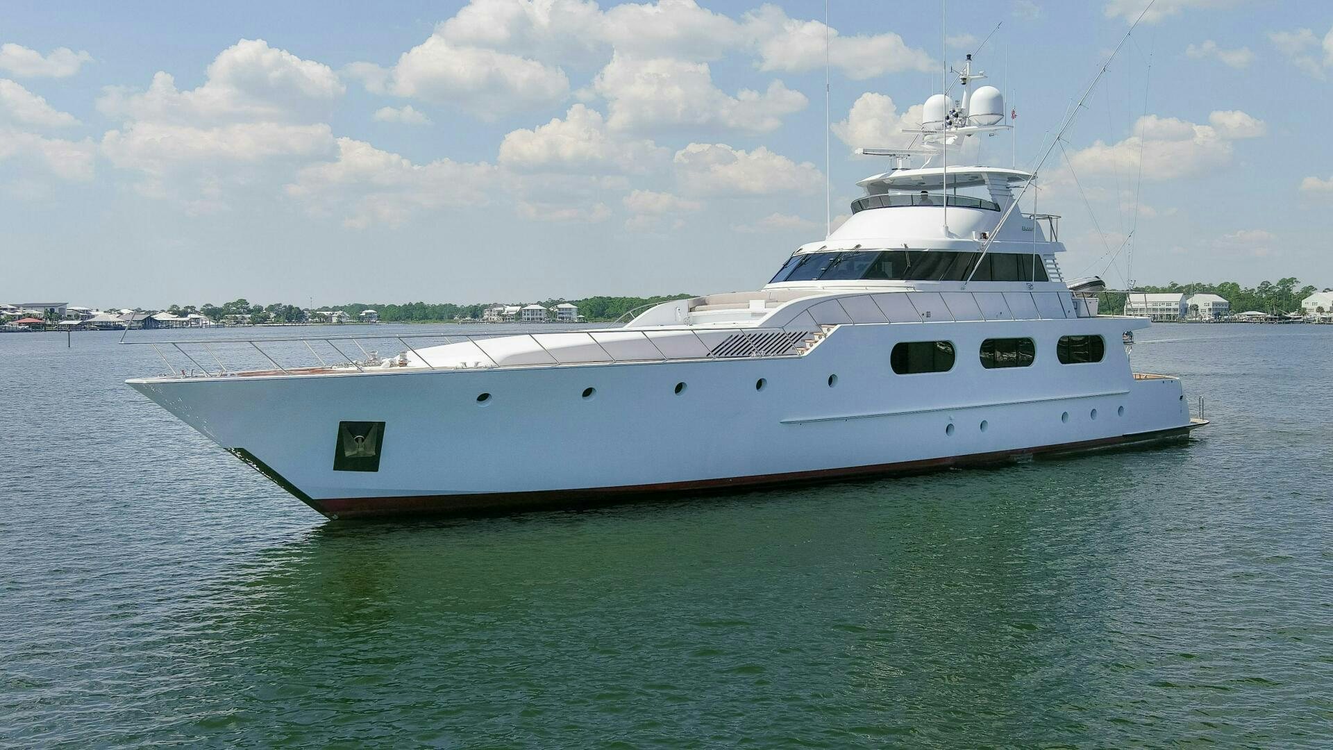 a white boat in the water aboard BOSS Yacht for Sale