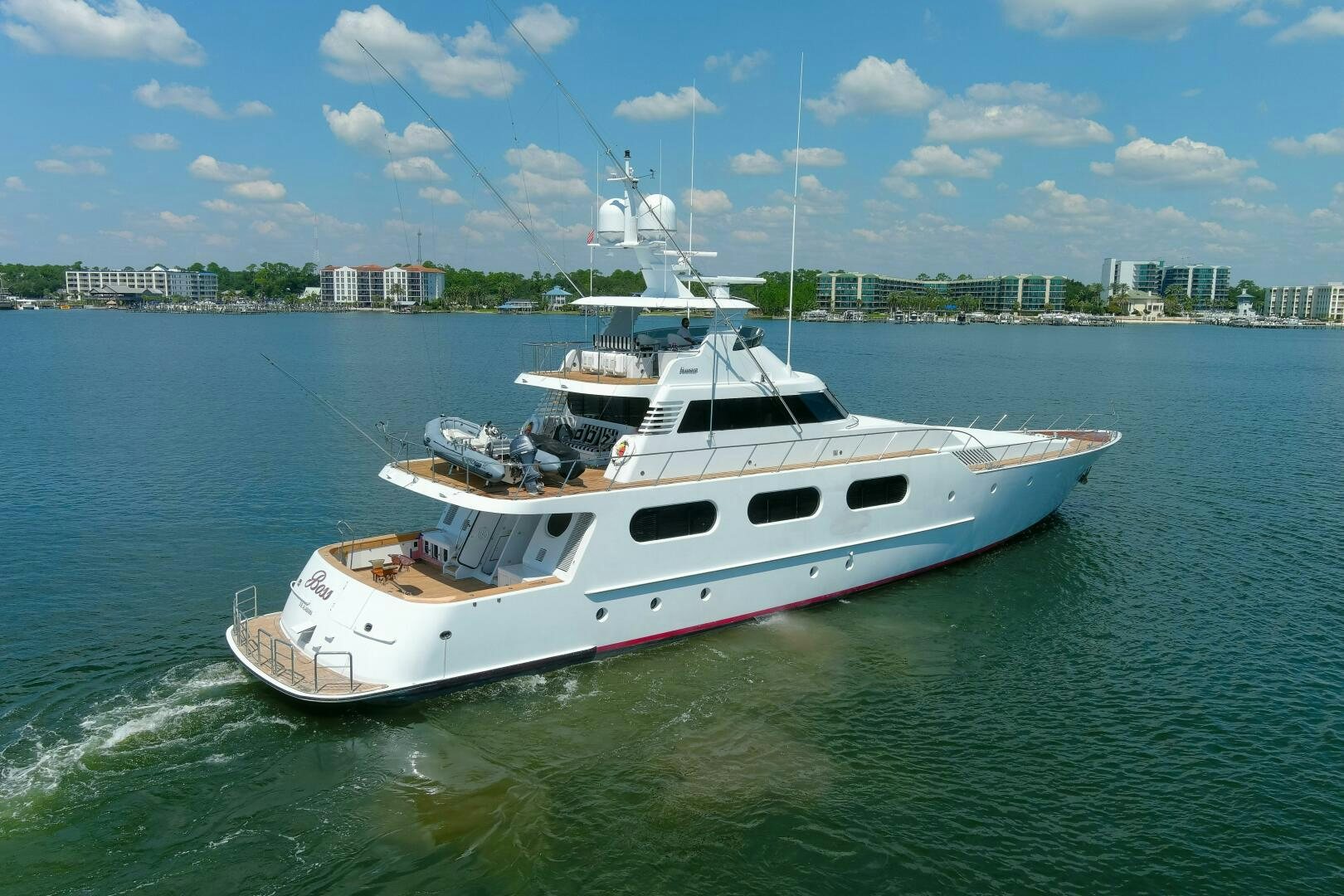 a white and red boat in the water aboard BOSS Yacht for Sale