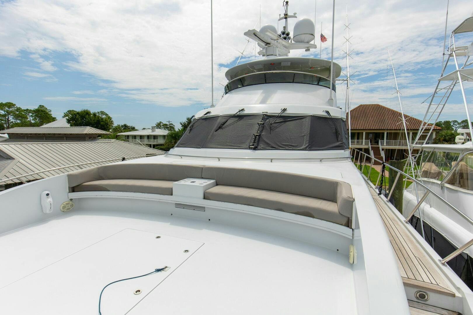 a white boat with a white sail aboard BOSS Yacht for Sale