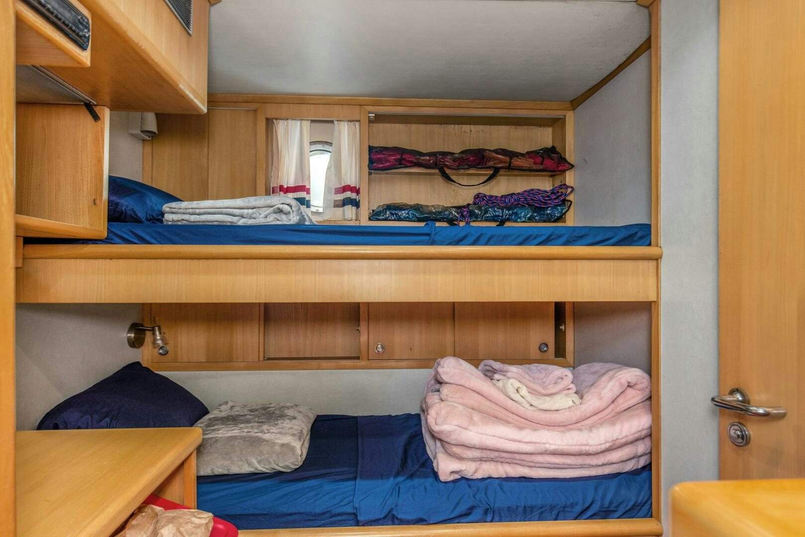 a room with a bed and a desk aboard BOSS Yacht for Sale