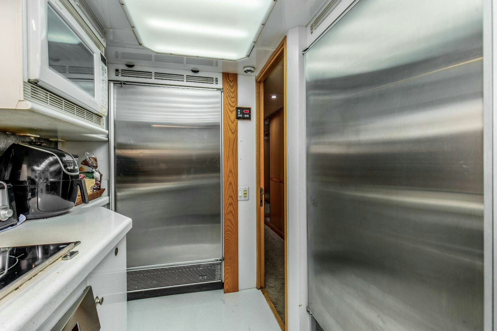 a kitchen with a glass door aboard BOSS Yacht for Sale