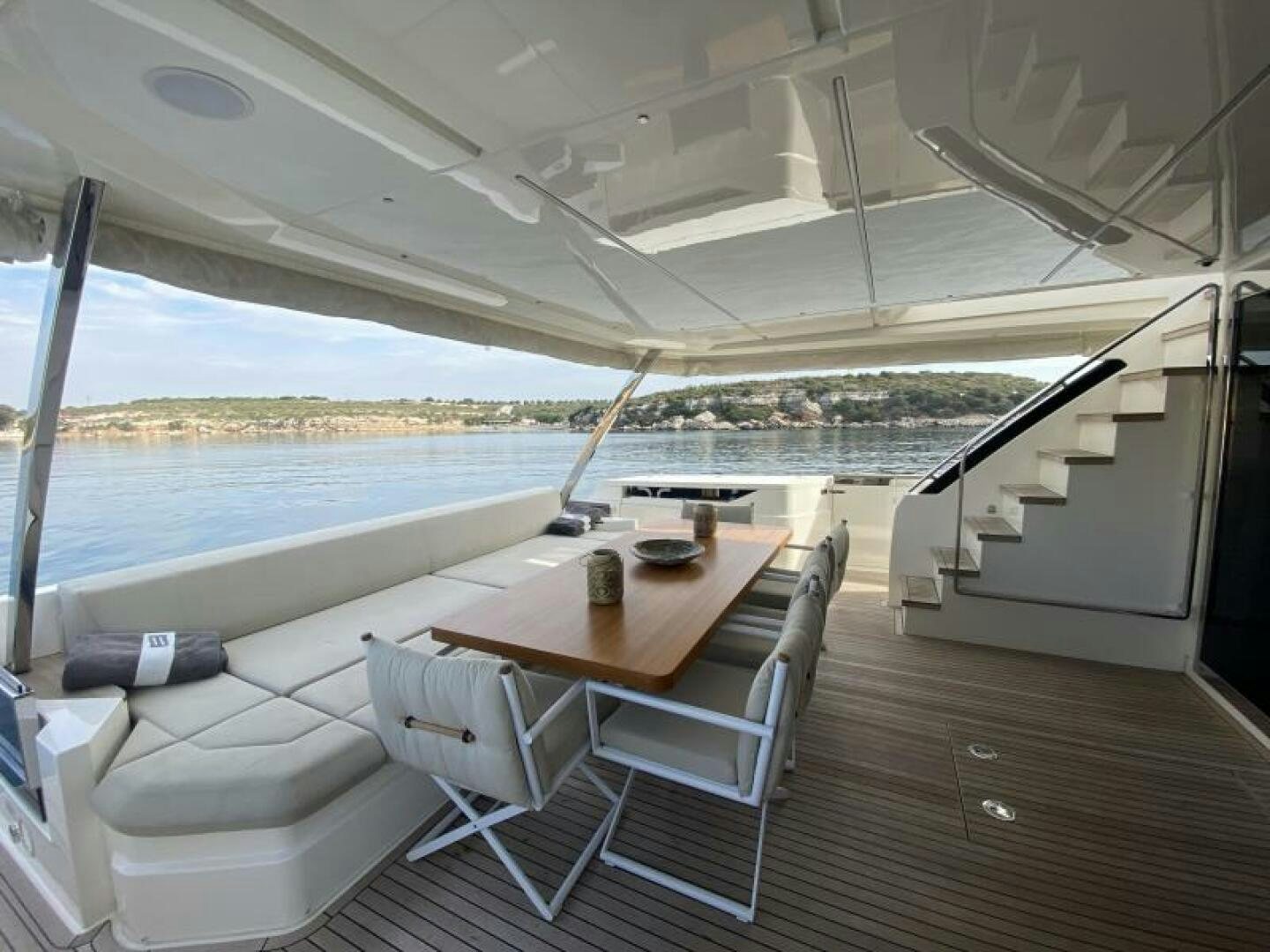 a large white lounge chair on a deck overlooking a body of water aboard SUNRISE - DELETE Yacht for Sale