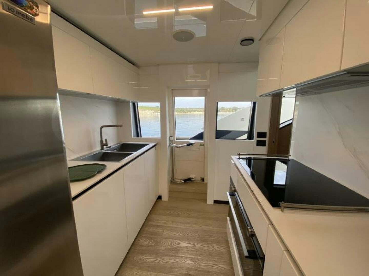 a kitchen with a large refrigerator aboard SUNRISE - DELETE Yacht for Sale
