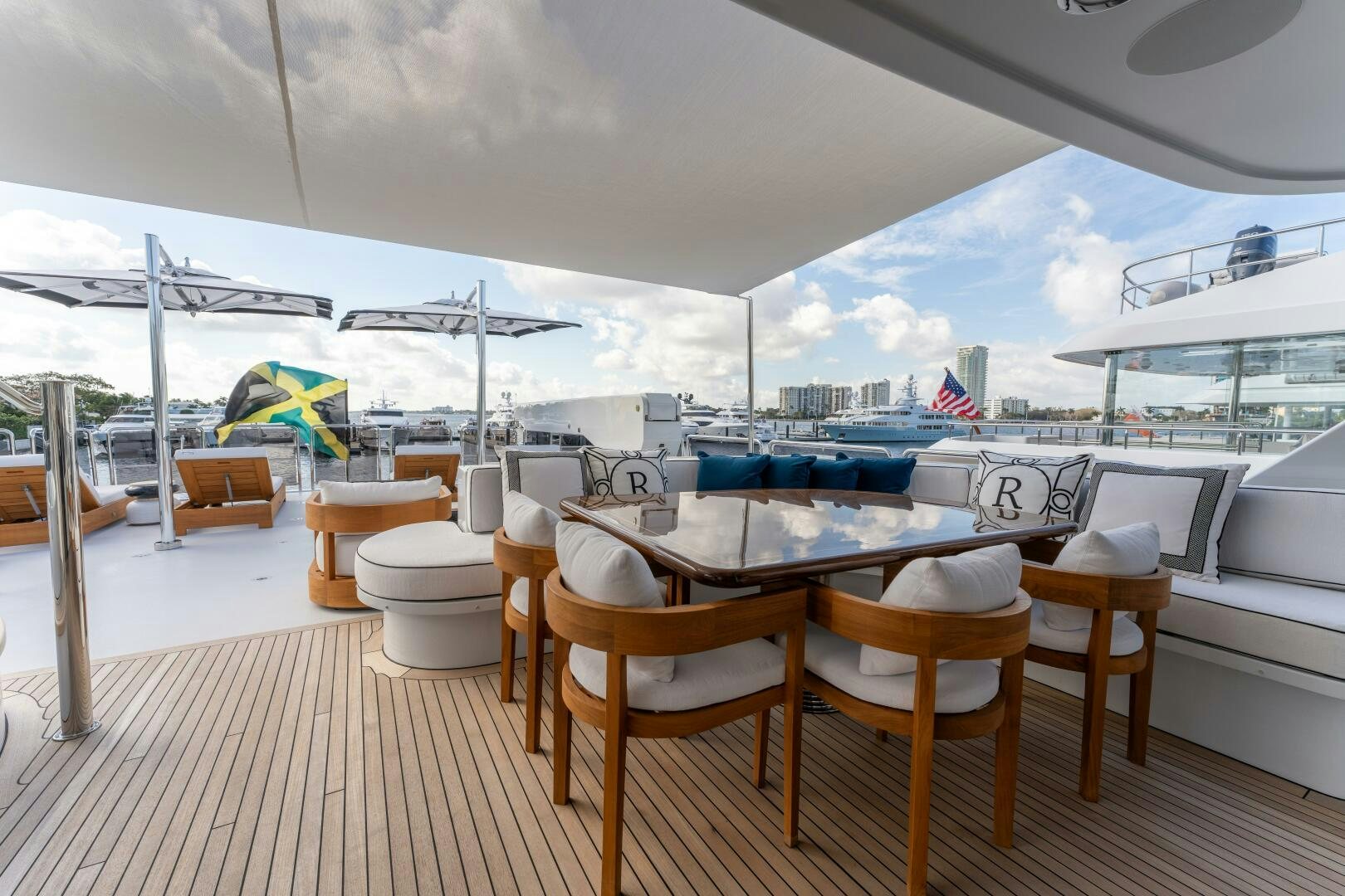 a deck with a table and chairs aboard RELENTLESS Yacht for Sale