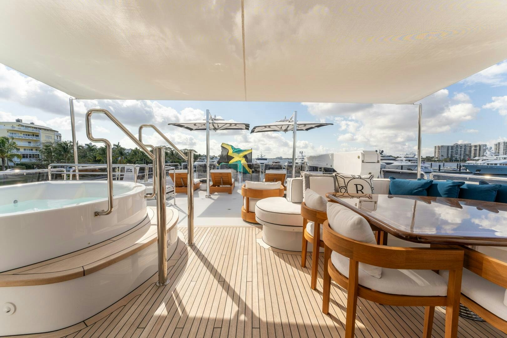 a deck with a view of the water and boats aboard RELENTLESS Yacht for Sale