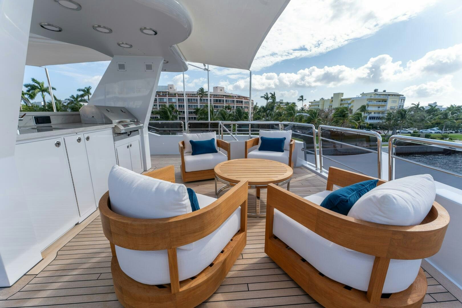 a room with a table chairs and a view of a city aboard RELENTLESS Yacht for Sale