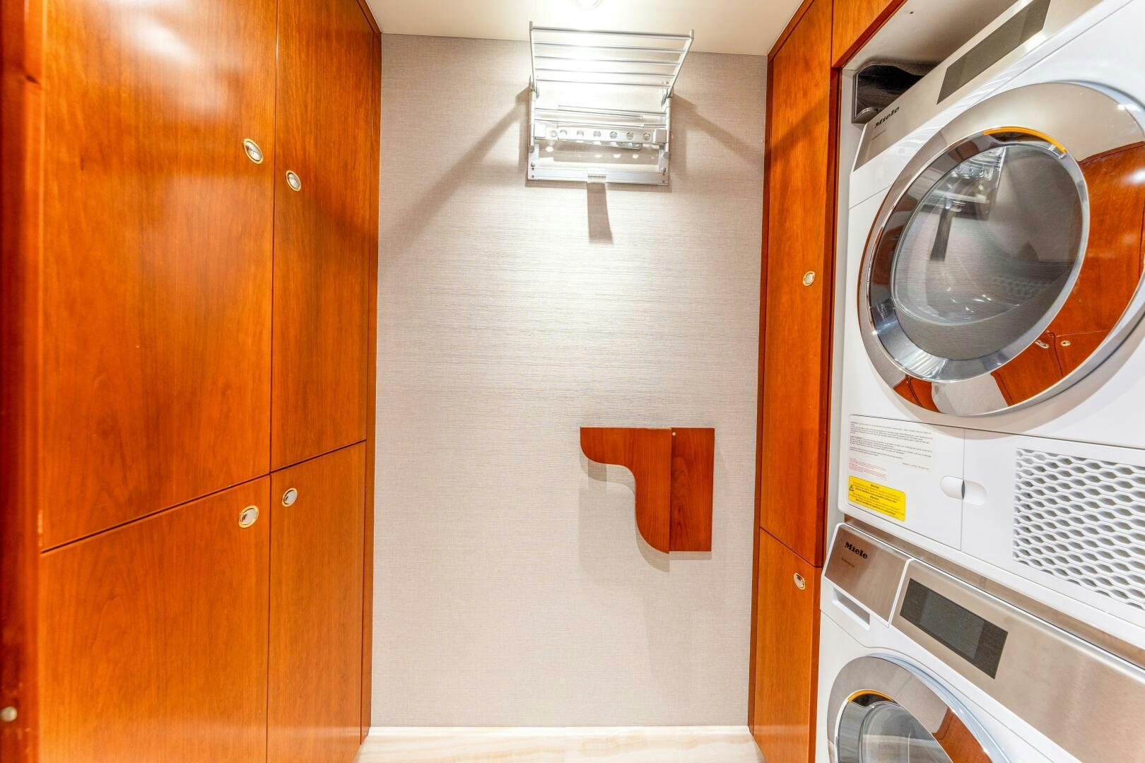 a room with a washing machine and dryer aboard RELENTLESS Yacht for Sale