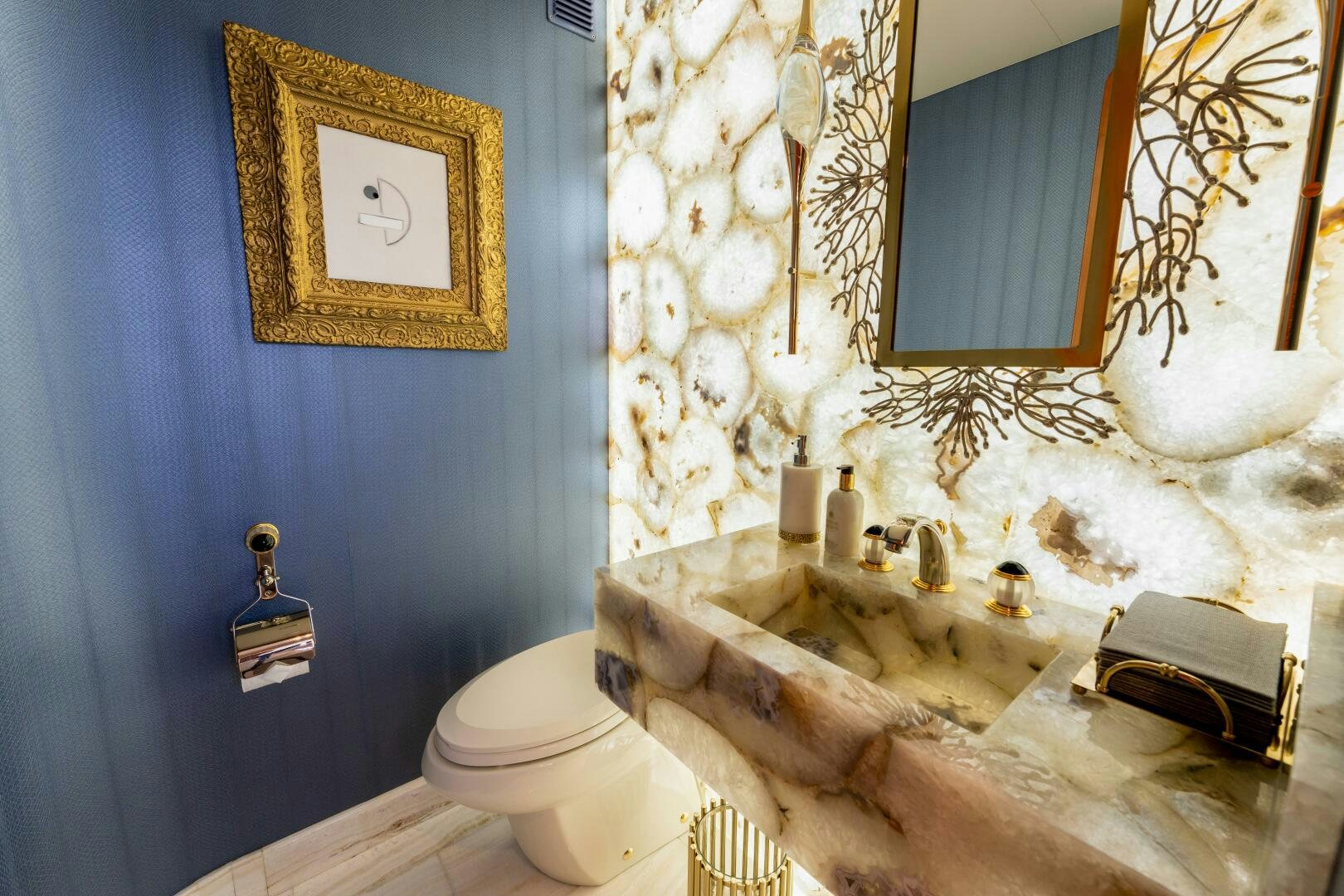 a bathroom with a sink toilet and a mirror aboard RELENTLESS Yacht for Sale