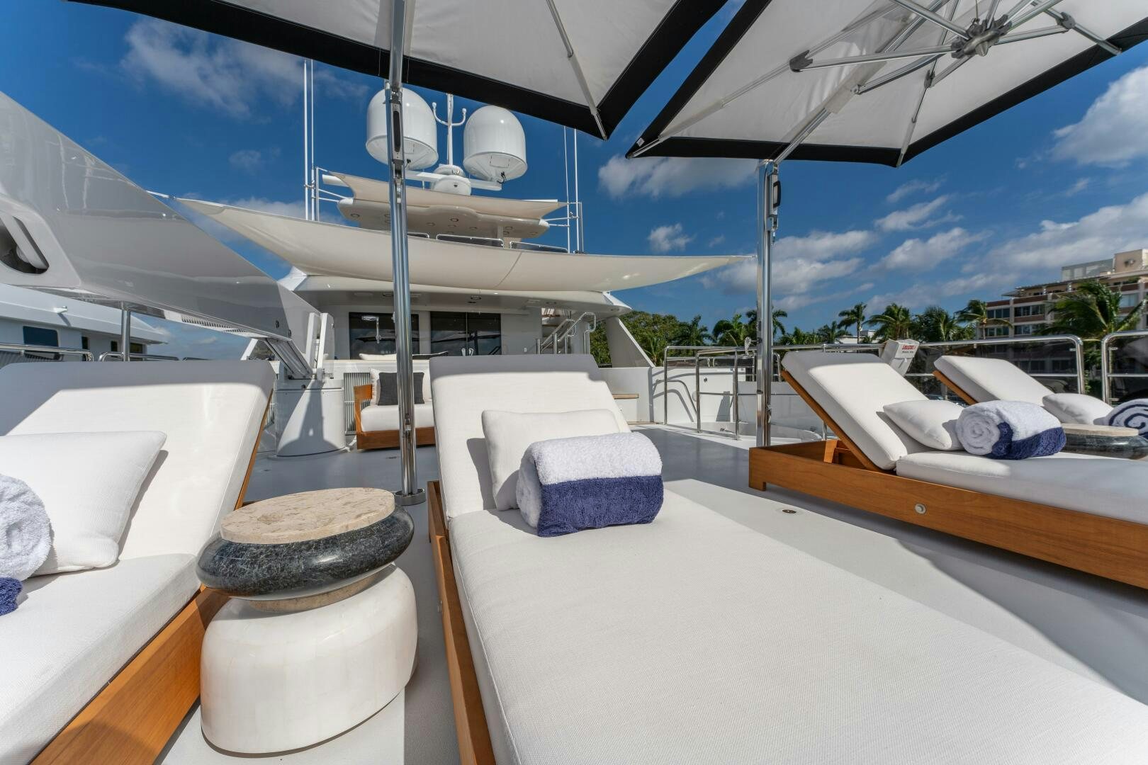 a boat with a bed and a bench on the deck aboard RELENTLESS Yacht for Sale