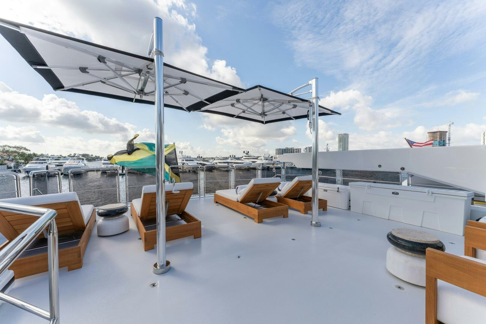 a large white tent with chairs and umbrellas on it aboard RELENTLESS Yacht for Sale