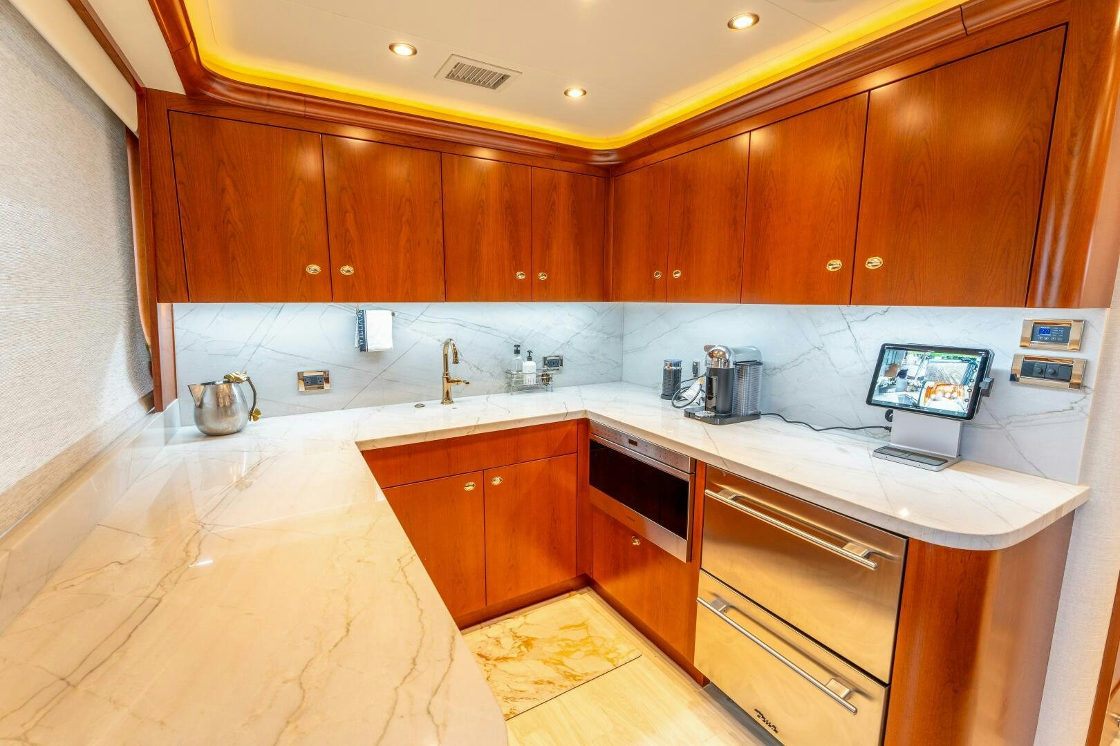 a kitchen with wooden cabinets aboard RELENTLESS Yacht for Sale