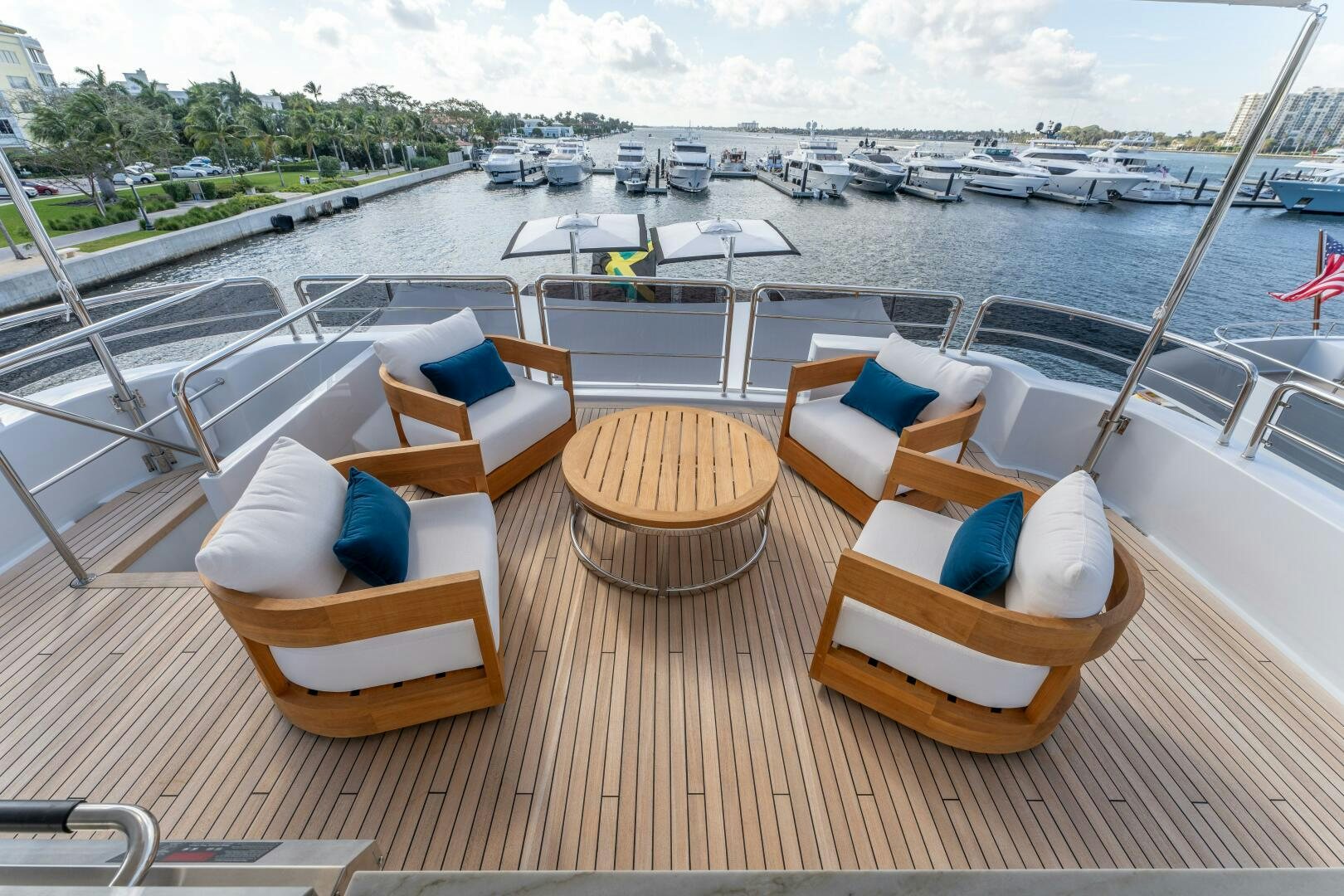 a deck with chairs and boats in the water aboard RELENTLESS Yacht for Sale