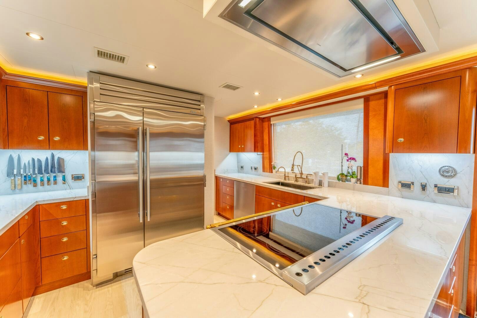 a kitchen with a stainless steel refrigerator aboard RELENTLESS Yacht for Sale